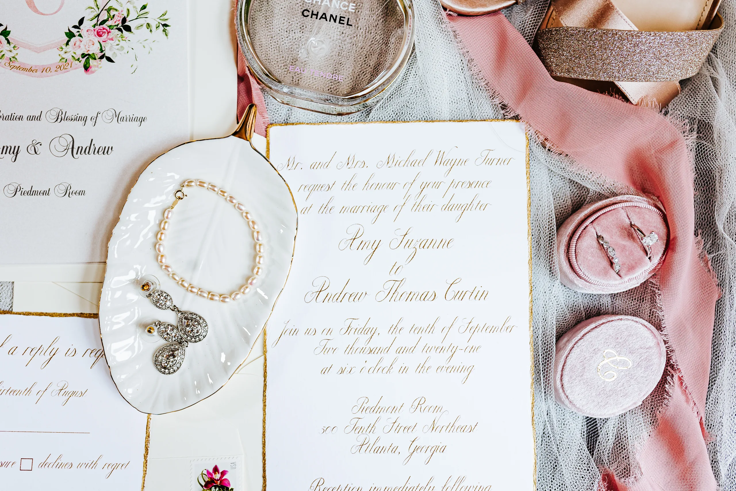 Wedding Details: the invitation suite with her pearl bracelet and velvet ring boxes, at a wedding at The Piedmont Room in Atlanta, GA