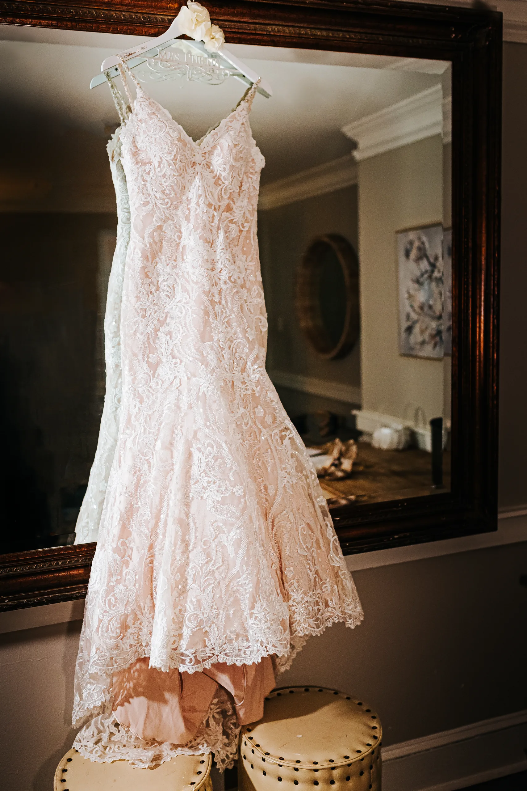 Wedding Details: her blush lace gown hanging on the mirror, before their wedding at The Piedmont Room in Atlanta, GA