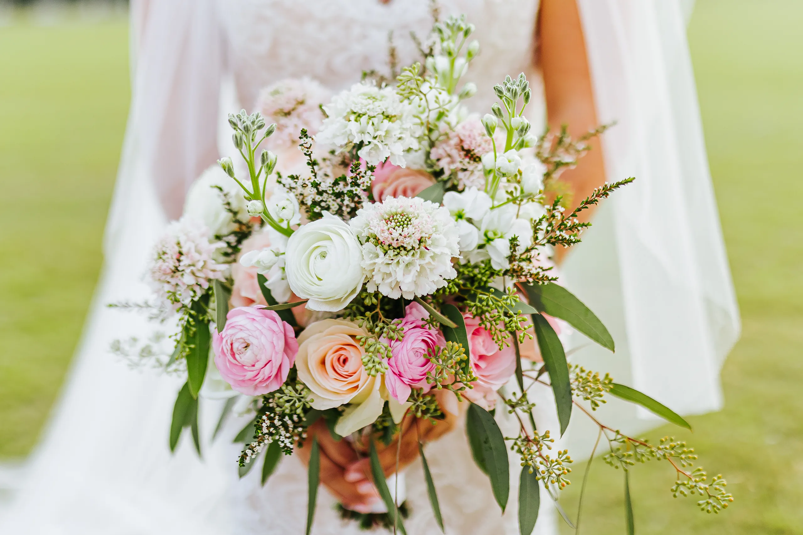 Wedding Florals: her bouquet of pink and white roses and ranunculus, at their wedding at The Piedmont Room in Atlanta, GA