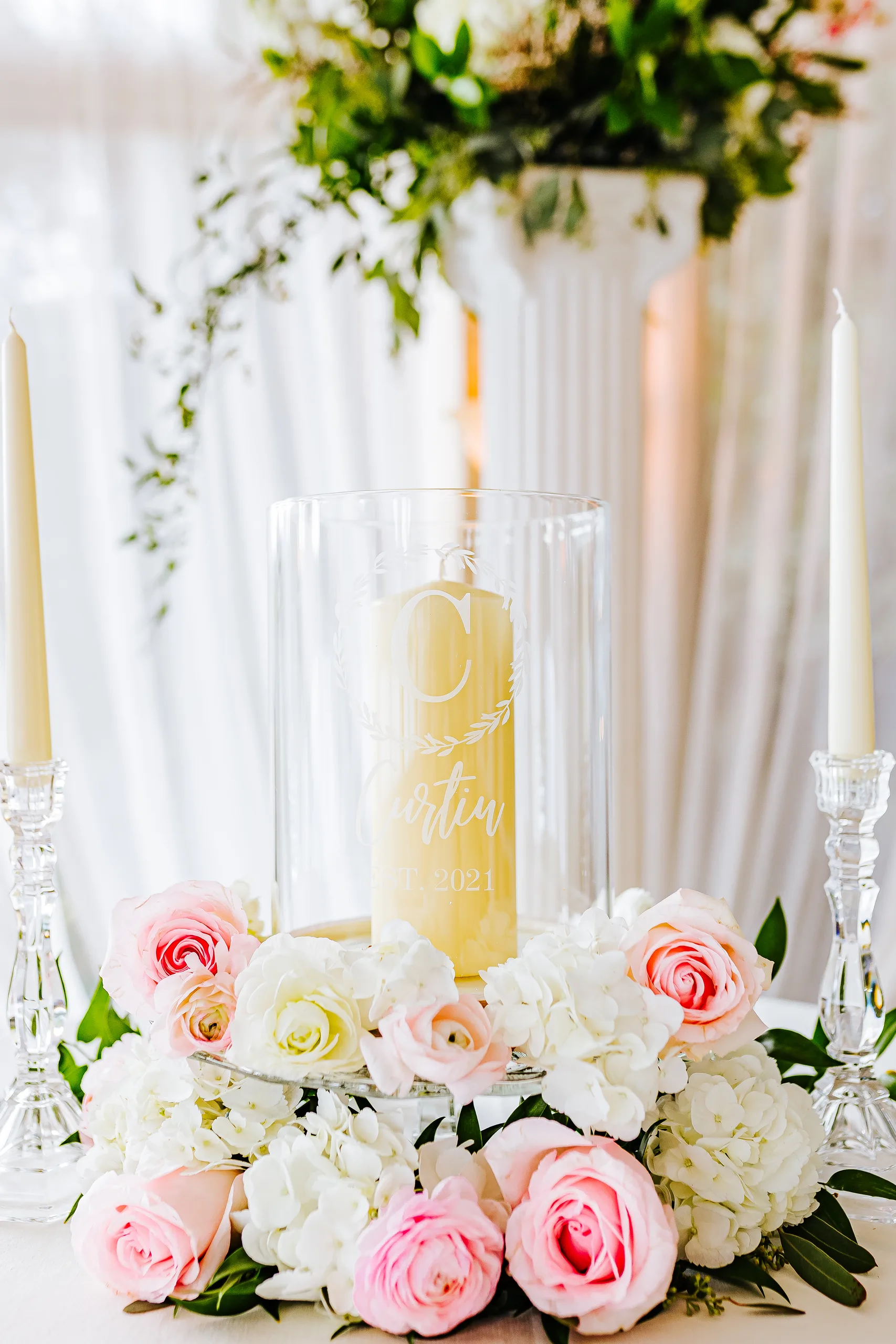Wedding Details: their unity candle ringed with pink roses, at a wedding at The Piedmont Room in Atlanta, GA