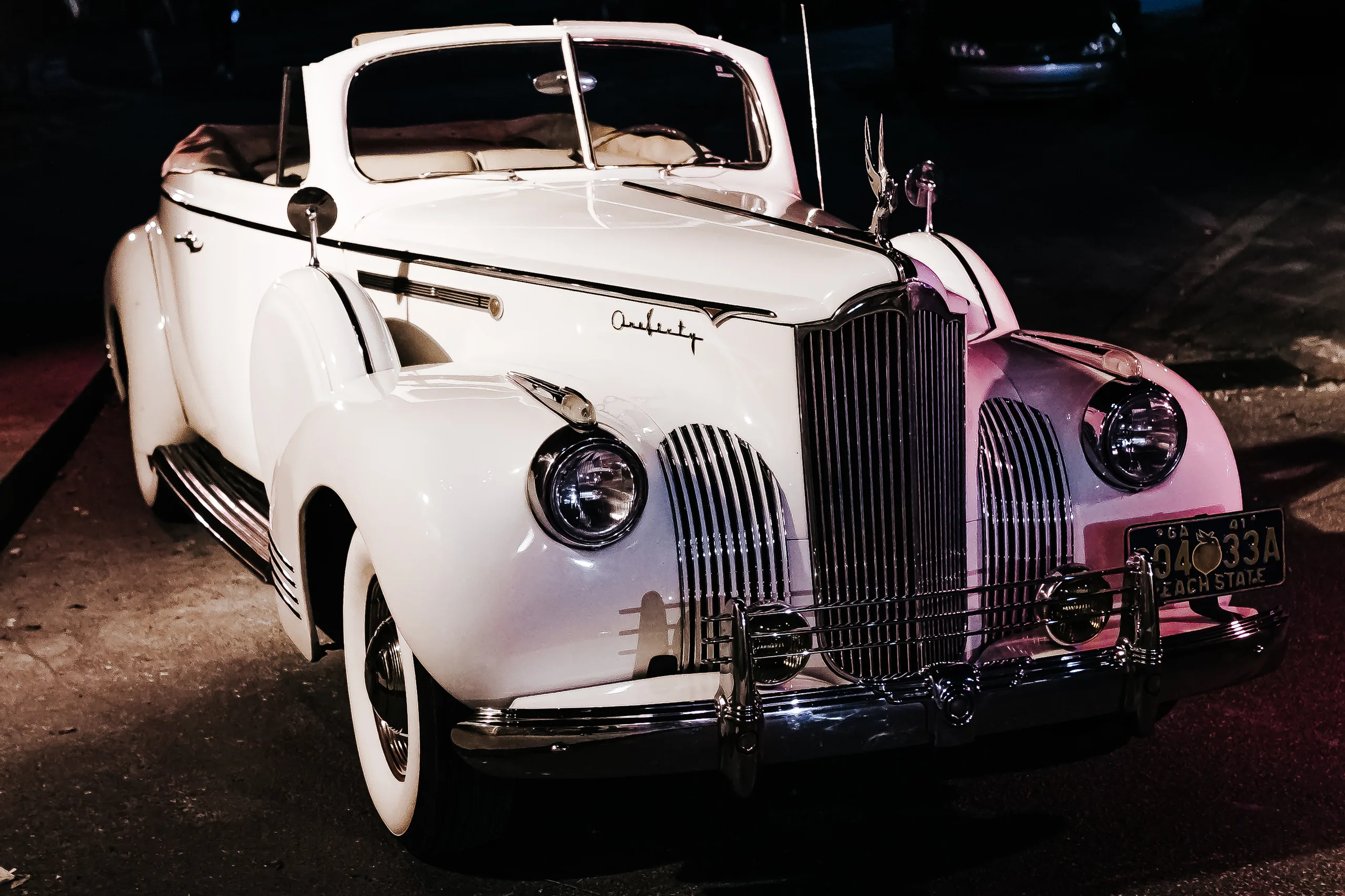 Send-Off: the vintage white Packard convertible waiting at night, at their wedding at The Piedmont Room in Atlanta, GA
