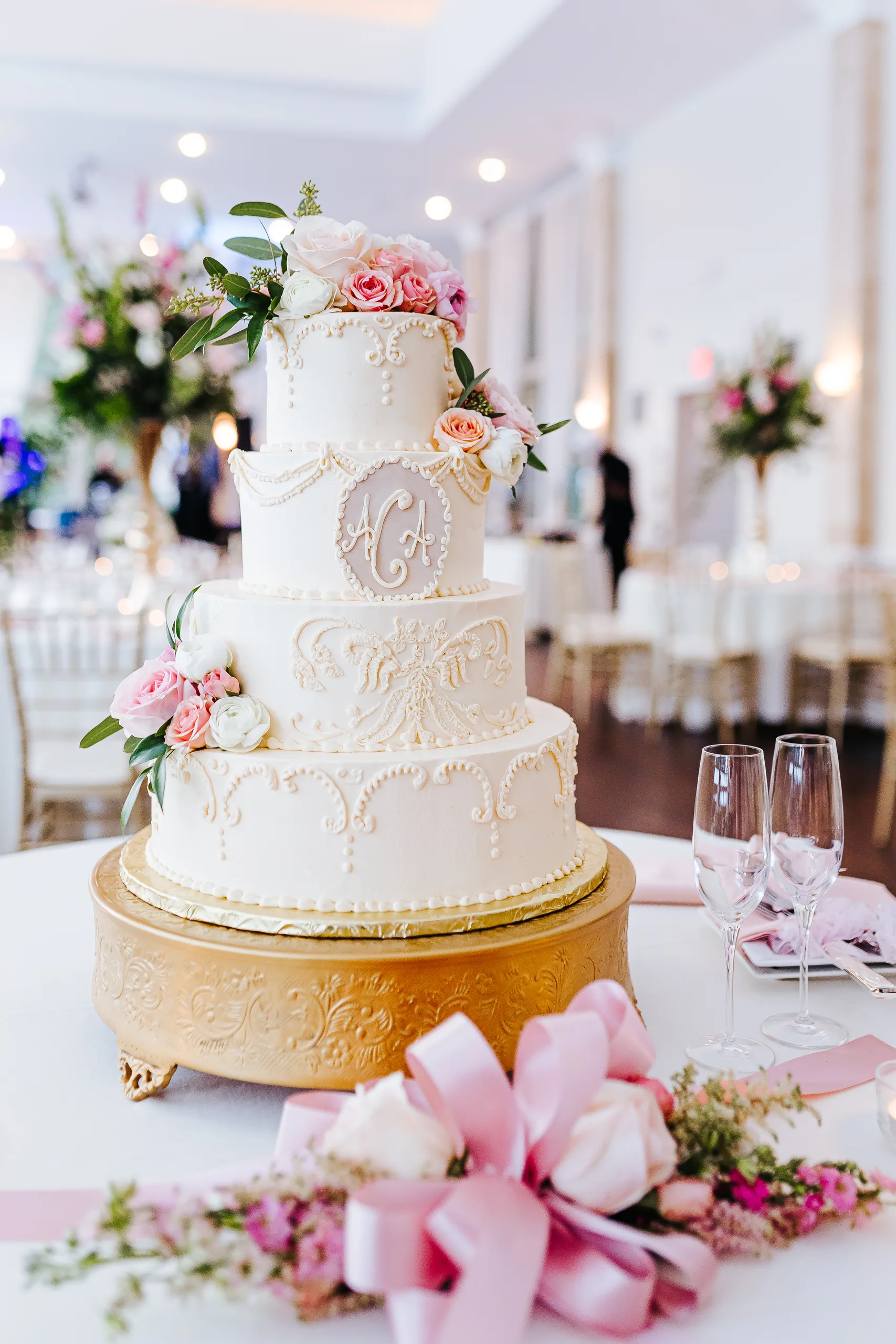 Wedding Cake Details: the four-tier white cake with their monogram on a gold stand, at a wedding at The Piedmont Room in Atlanta, GA