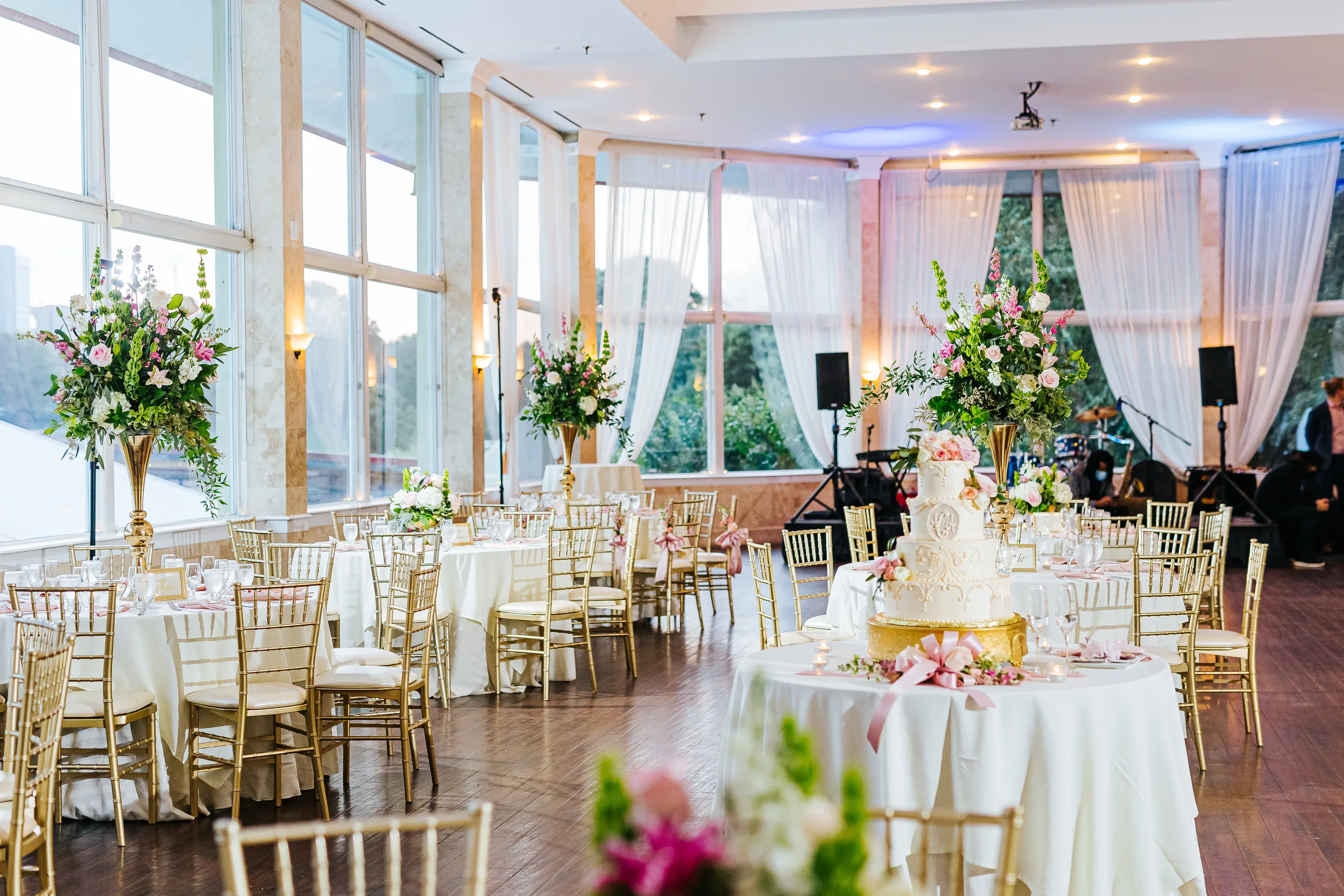 Reception Details: the reception set up by the big windows with the Midtown skyline outside, at a wedding at The Piedmont Room in Atlanta, GA