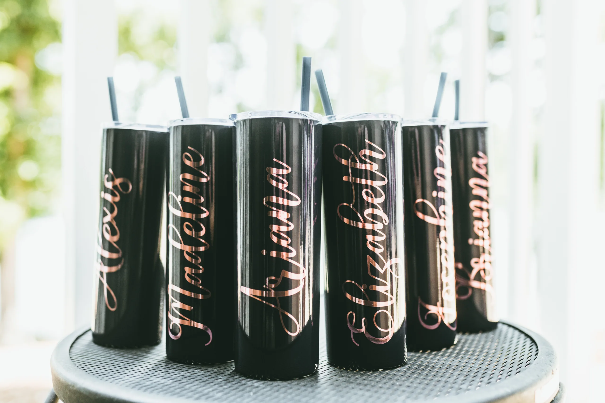 Wedding Details: black tumblers with the bridesmaids' names in rose gold, at a wedding at Atlanta Evergreen Lakeside Resort in Stone Mountain, GA
