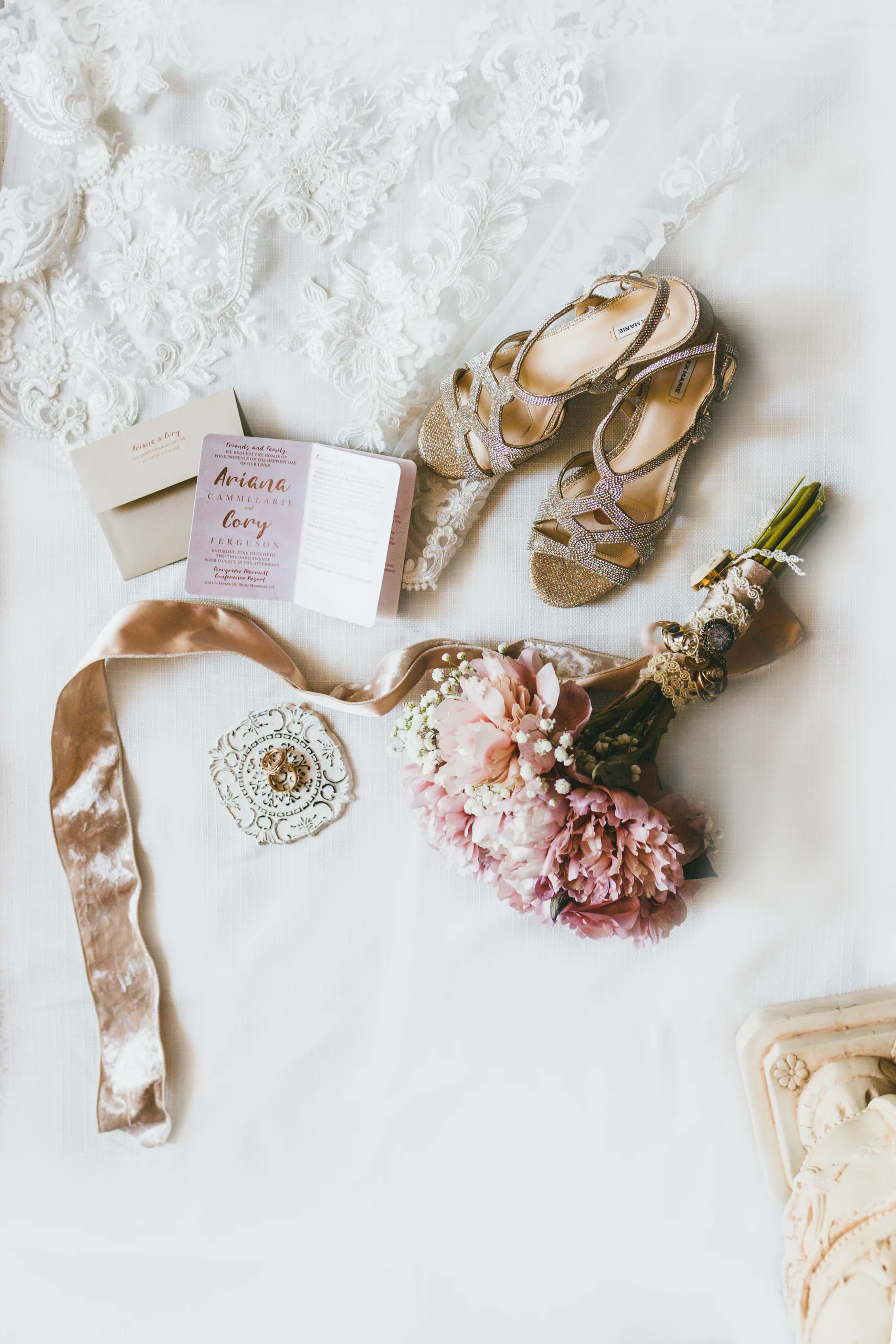 Wedding Details: her heels, invitation, rings and bouquet laid out on the bed, at a wedding at Atlanta Evergreen Lakeside Resort in Stone Mountain, GA