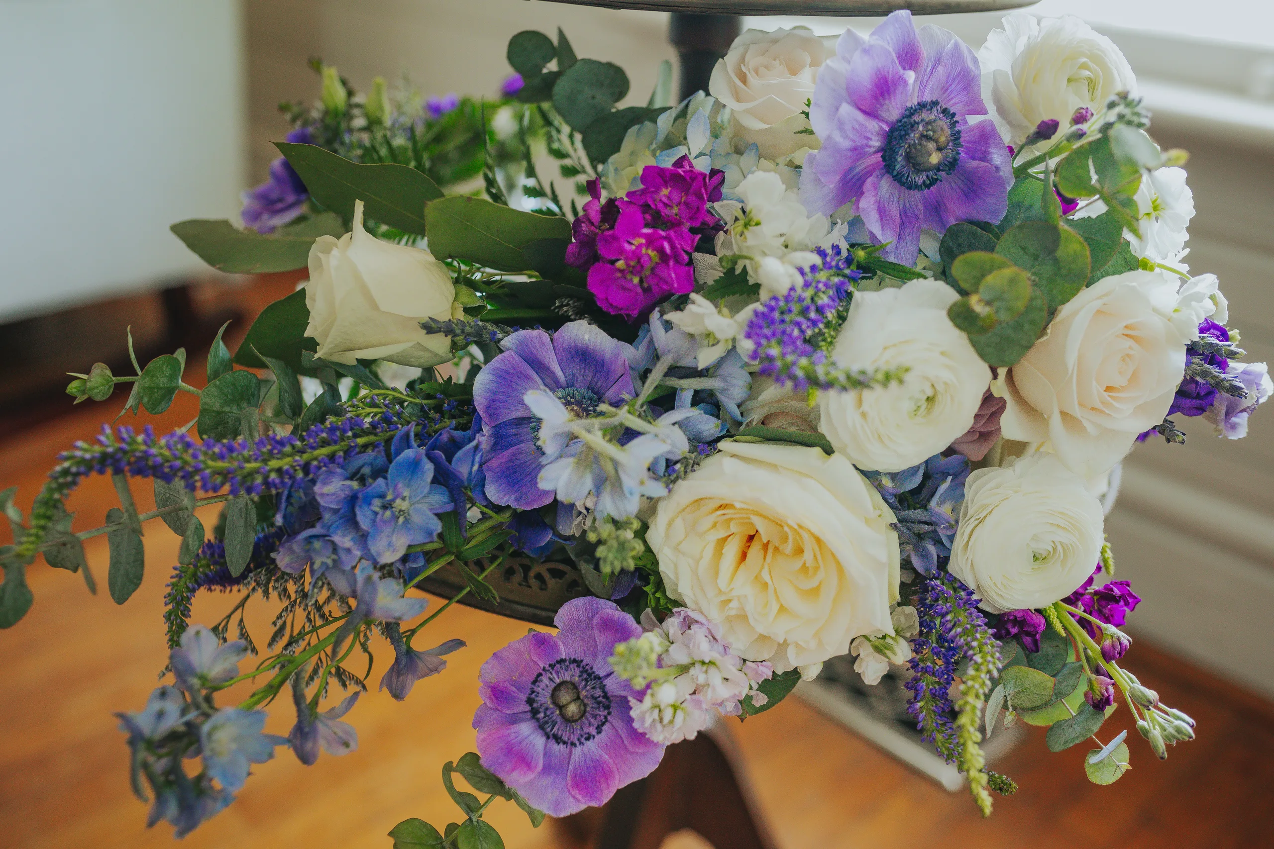 Wedding Florals: purple anemones, white roses and delphinium in her bouquet, at a wedding at The Wildflower 301 in Greensboro, GA
