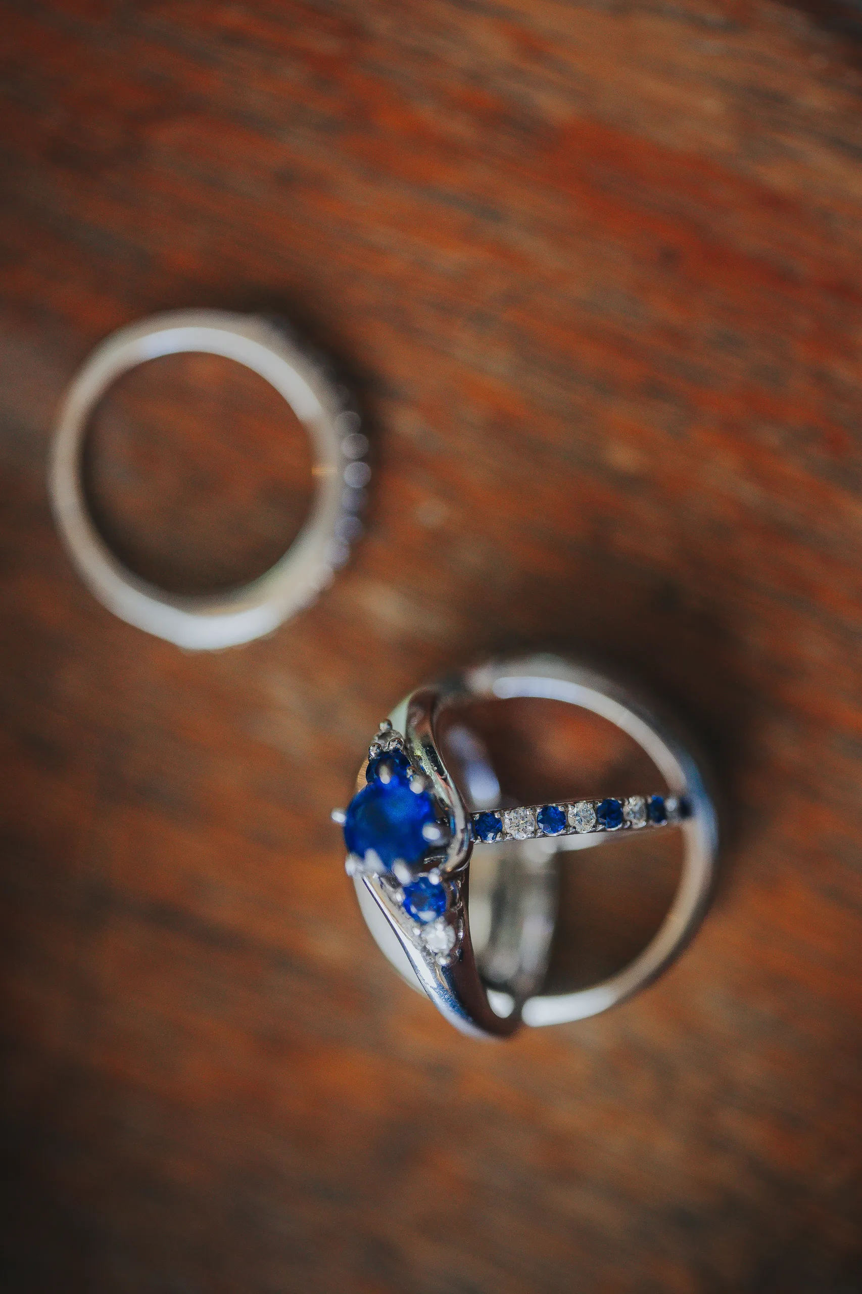 Wedding Details: her sapphire engagement ring and wedding bands, at a wedding at The Wildflower 301 in Greensboro, GA
