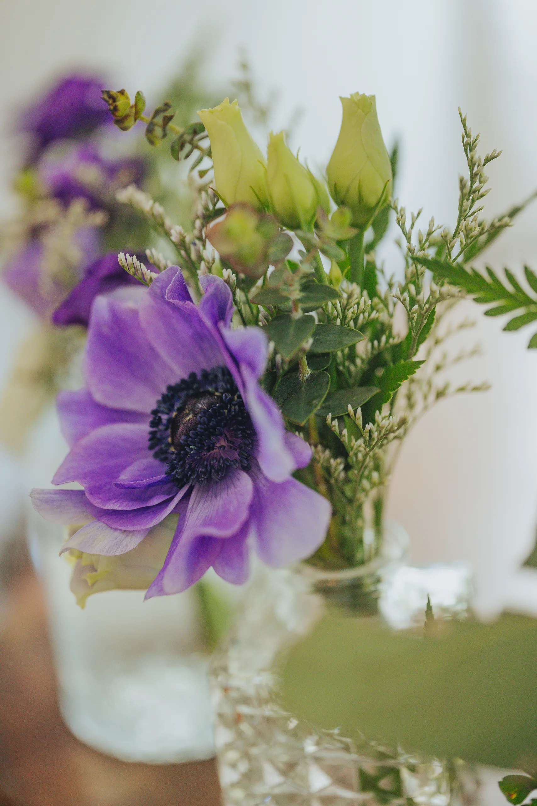 Wedding Florals: a purple anemone in a small glass vase, at a wedding at The Wildflower 301 in Greensboro, GA