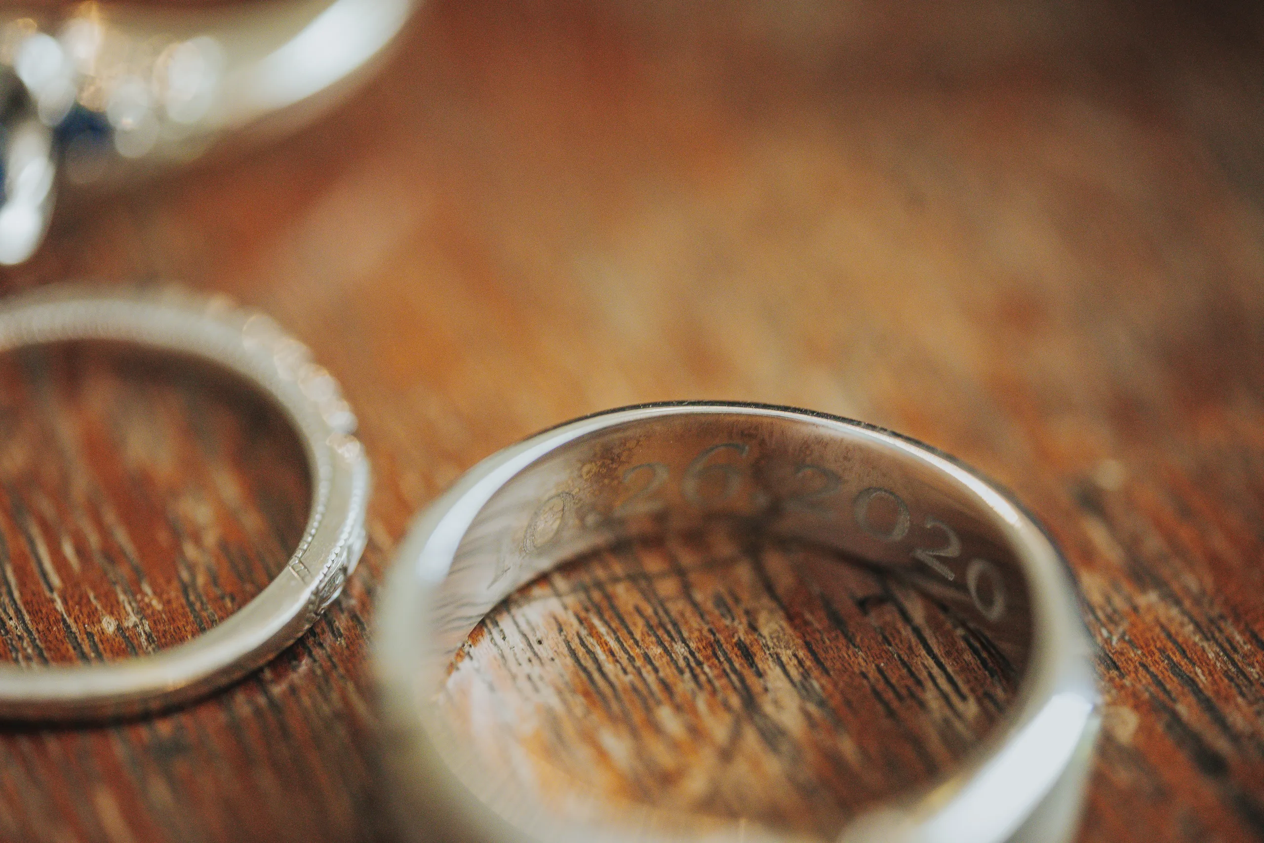 Wedding Details: their wedding bands on a wooden table, at a wedding at The Wildflower 301 in Greensboro, GA