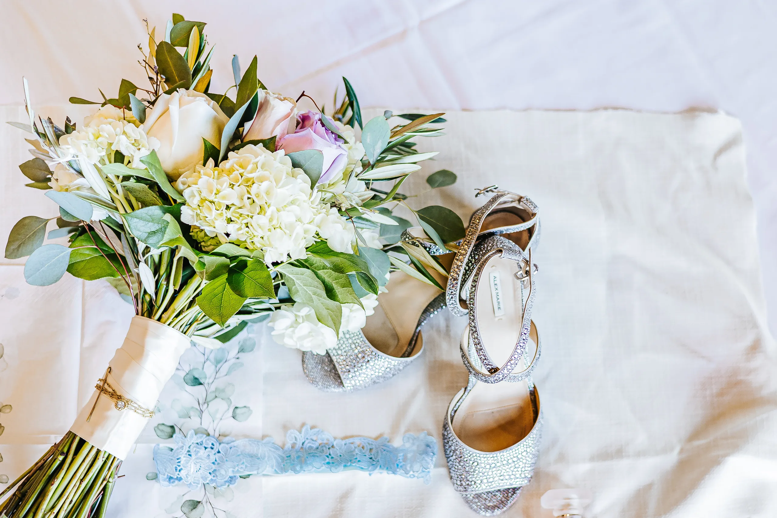 Wedding Details: her bouquet, sparkly heels and blue garter at a wedding at the Country Club of Roswell in Roswell, GA