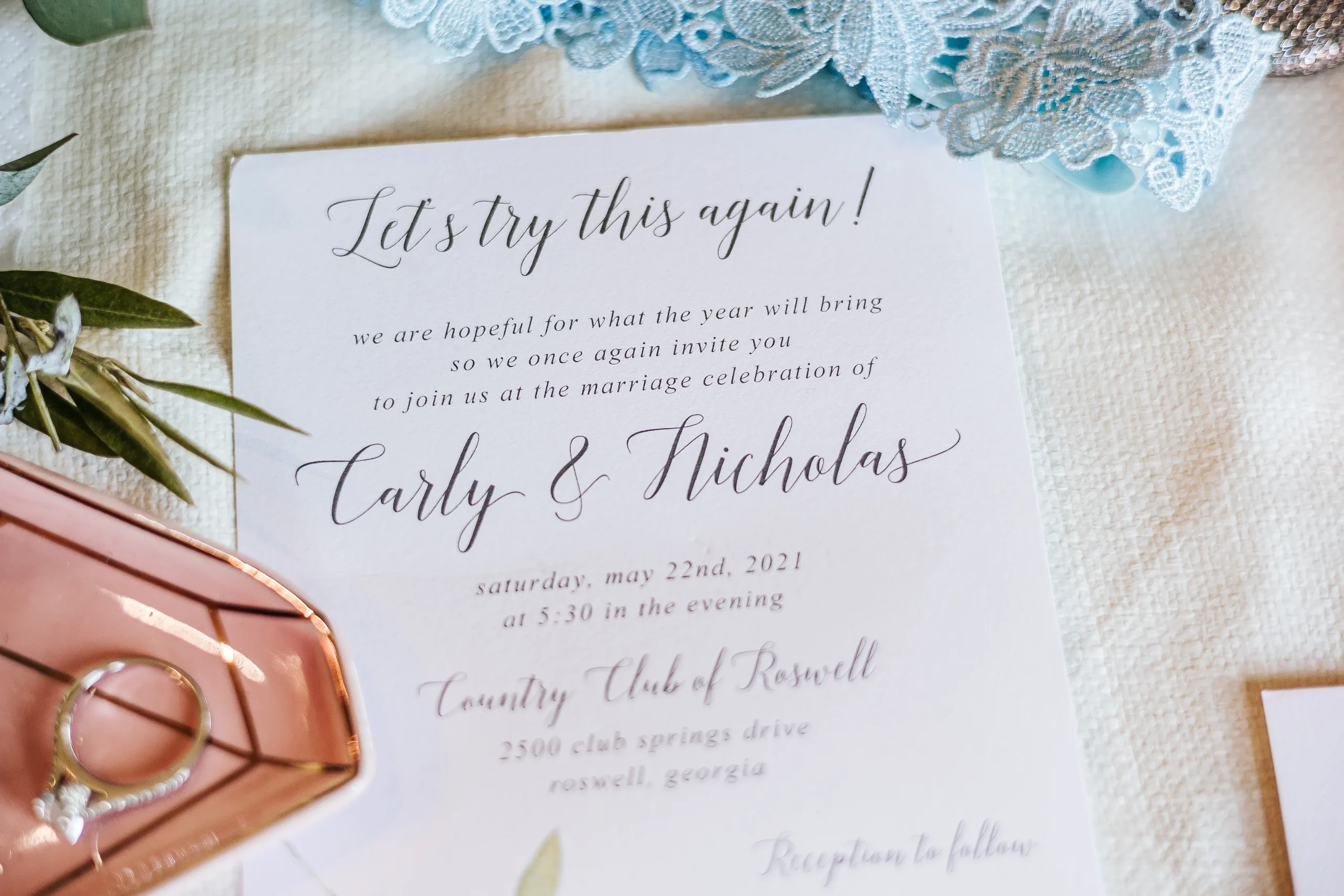 Wedding Details: their invitation reading Let's try this again, with her ring at a wedding at the Country Club of Roswell in Roswell, GA
