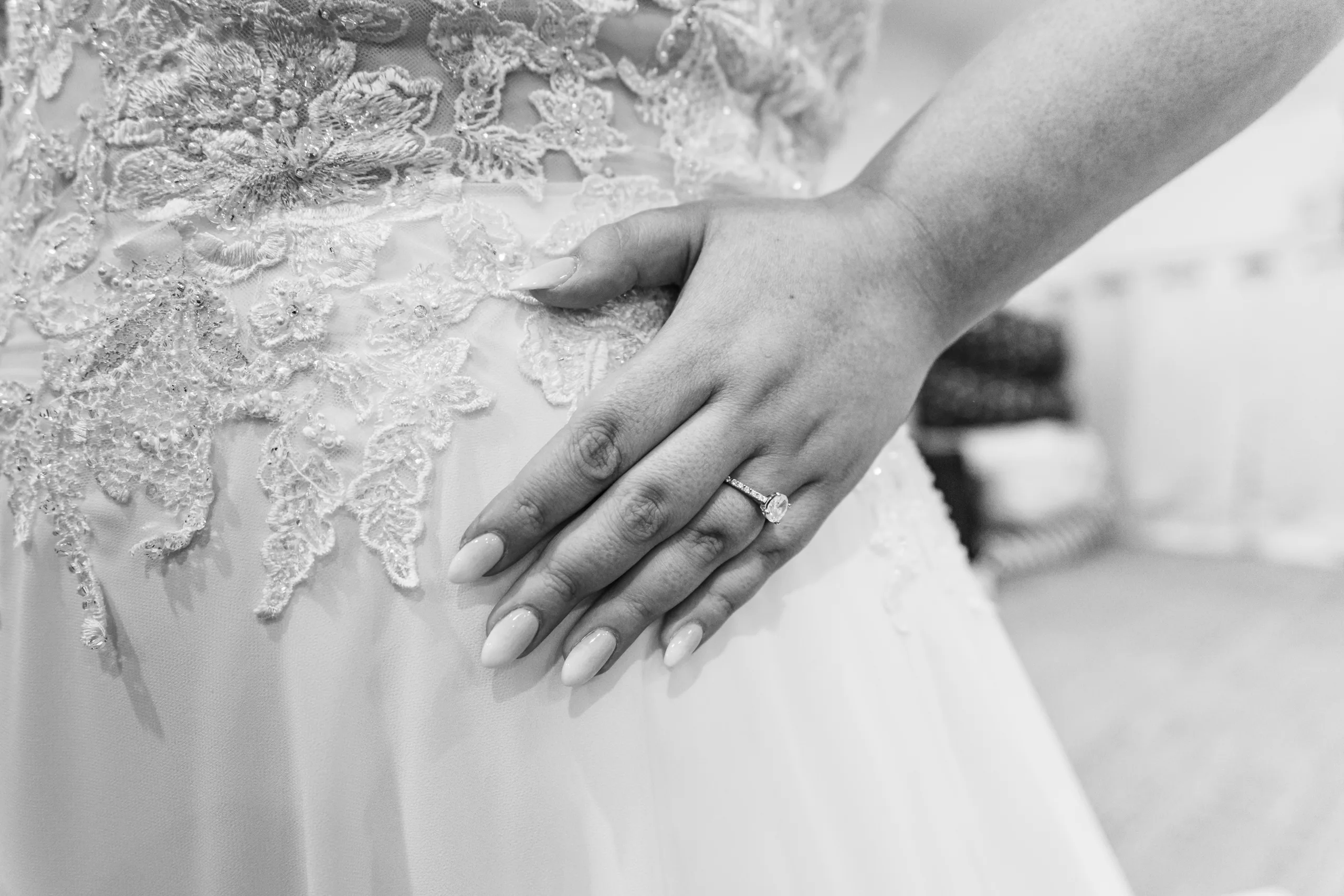 Wedding Details: her ring hand on her gown, in black and white before their wedding at the Country Club of Roswell in Roswell, GA