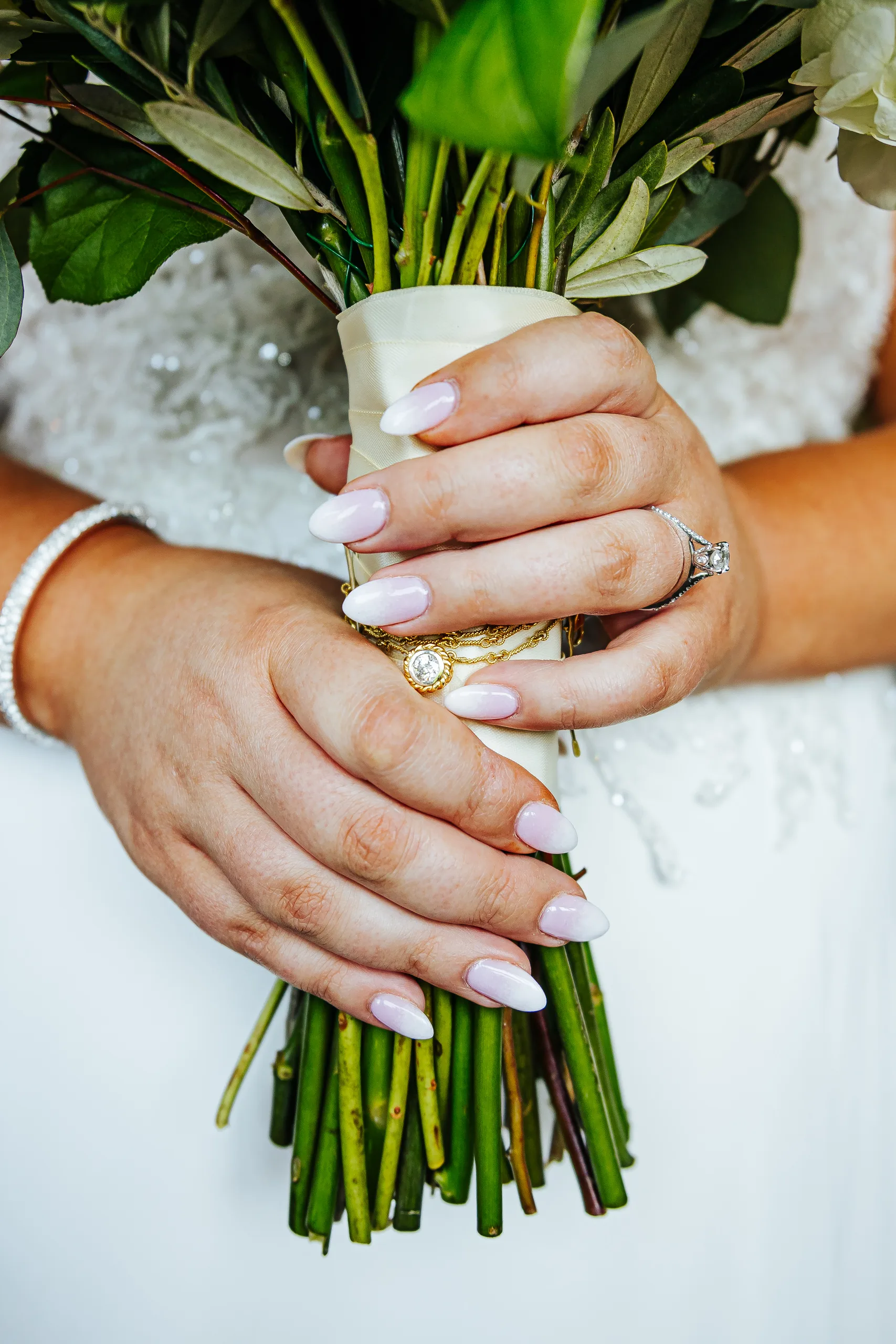 Wedding Details: her ring and locket on her bouquet at a wedding at the Country Club of Roswell in Roswell, GA