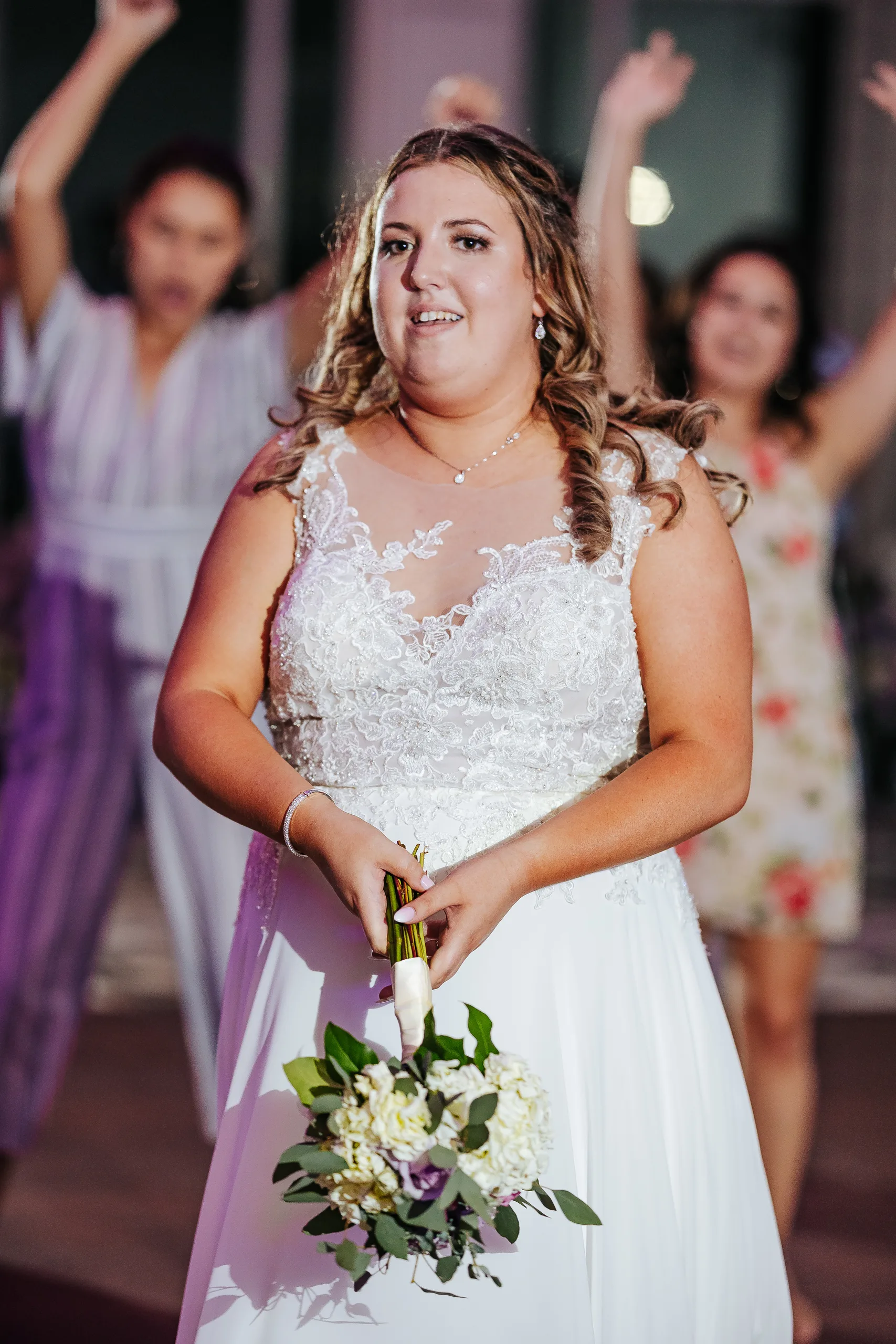 Reception: the bride getting ready to toss her bouquet at their wedding at the Country Club of Roswell in Roswell, GA