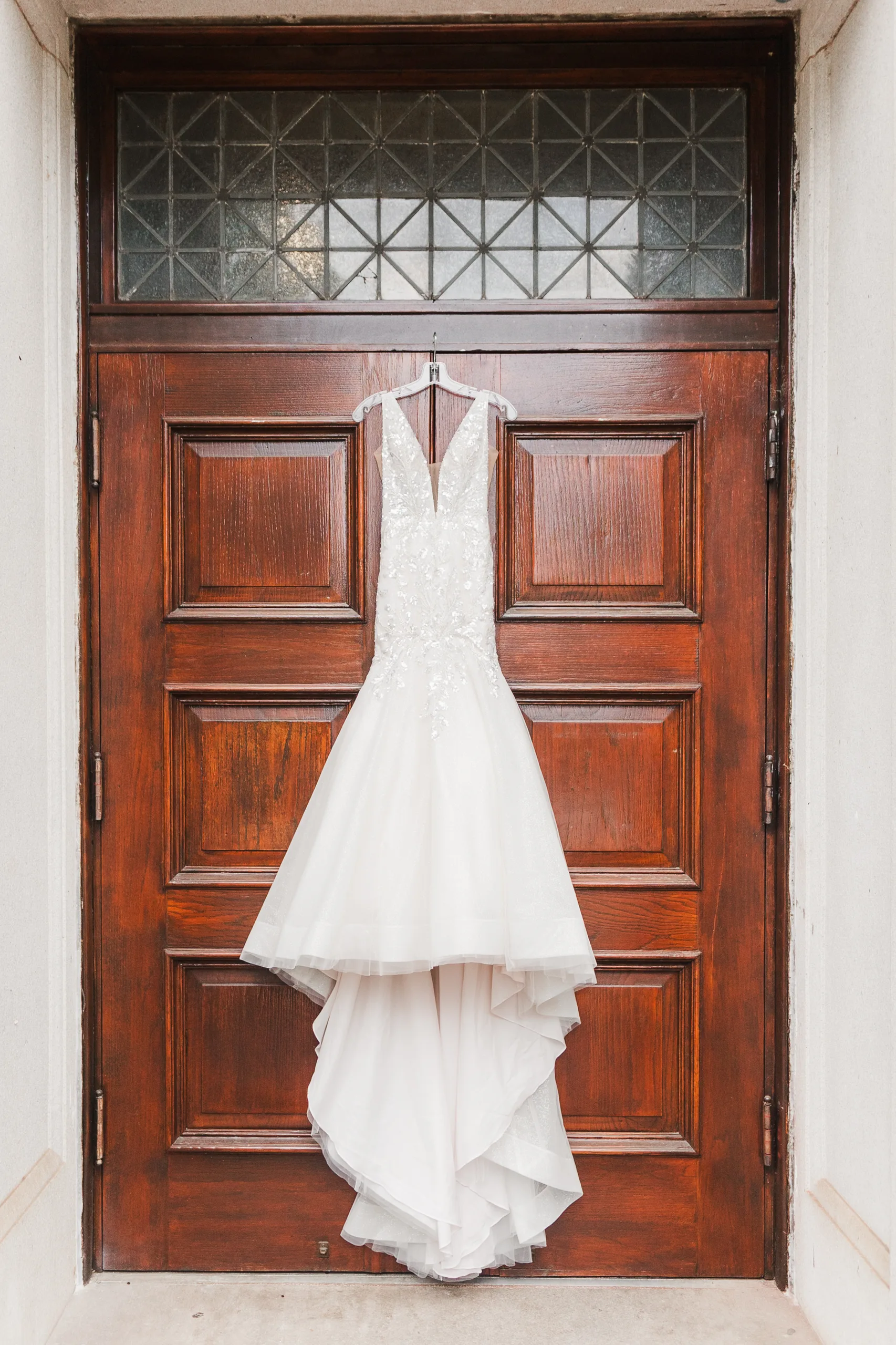 Wedding Details: her gown hanging on the courthouse's wooden front doors, at a wedding at the Historic DeKalb Courthouse in Decatur, GA