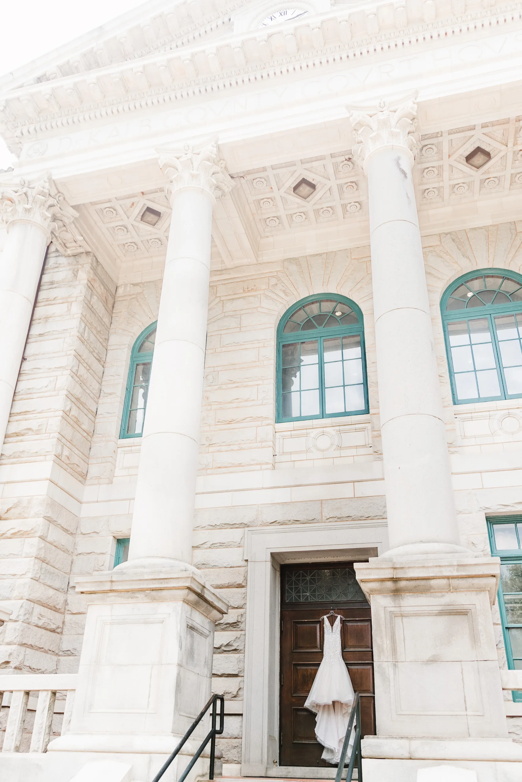 Wedding Details: her gown on the front doors below the courthouse columns, at a wedding at the Historic DeKalb Courthouse in Decatur, GA