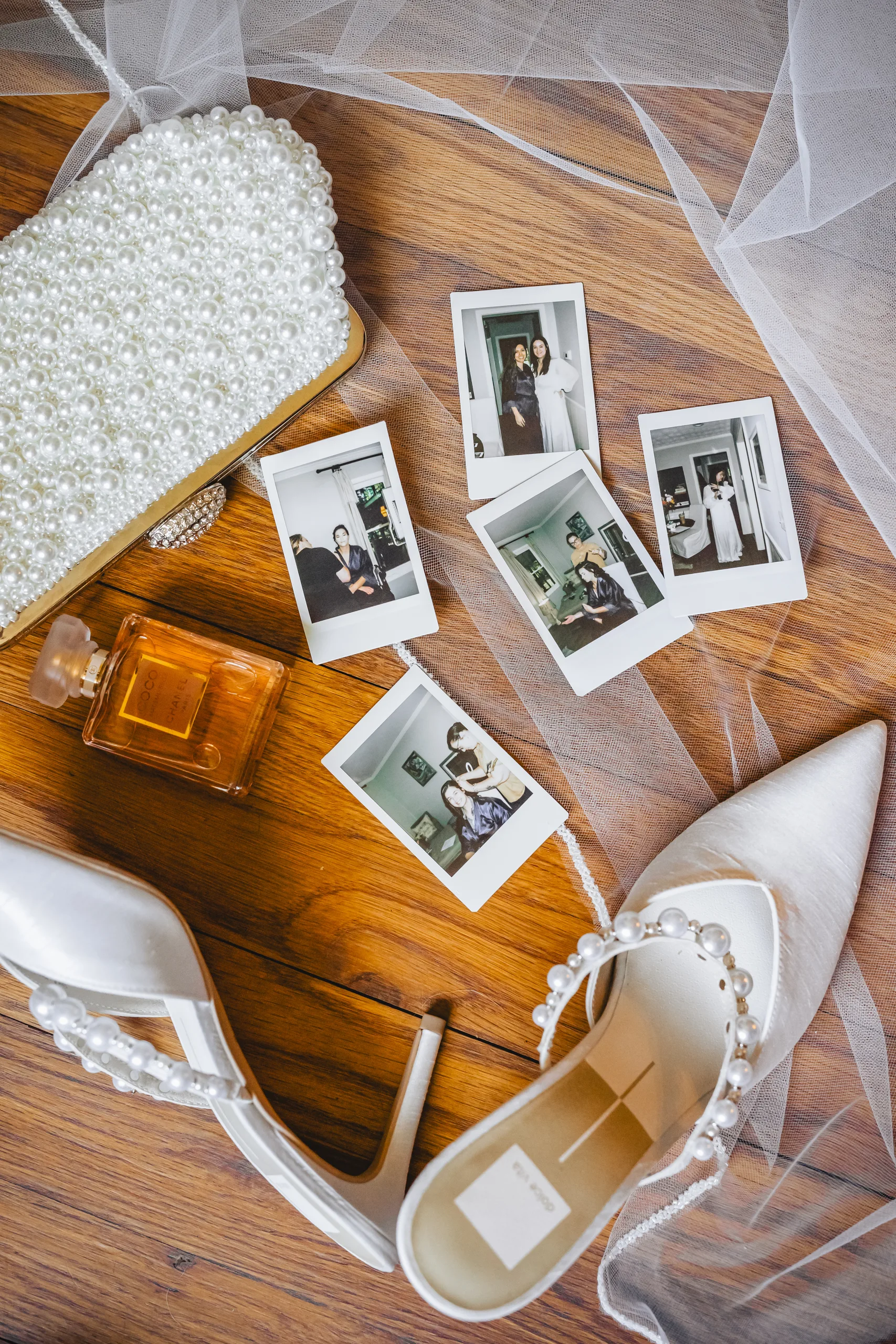 Wedding Details: instant photos of the two of them with her pearl clutch, perfume and heels at a wedding at Ivy Hall at Roswell Mill in Roswell, GA