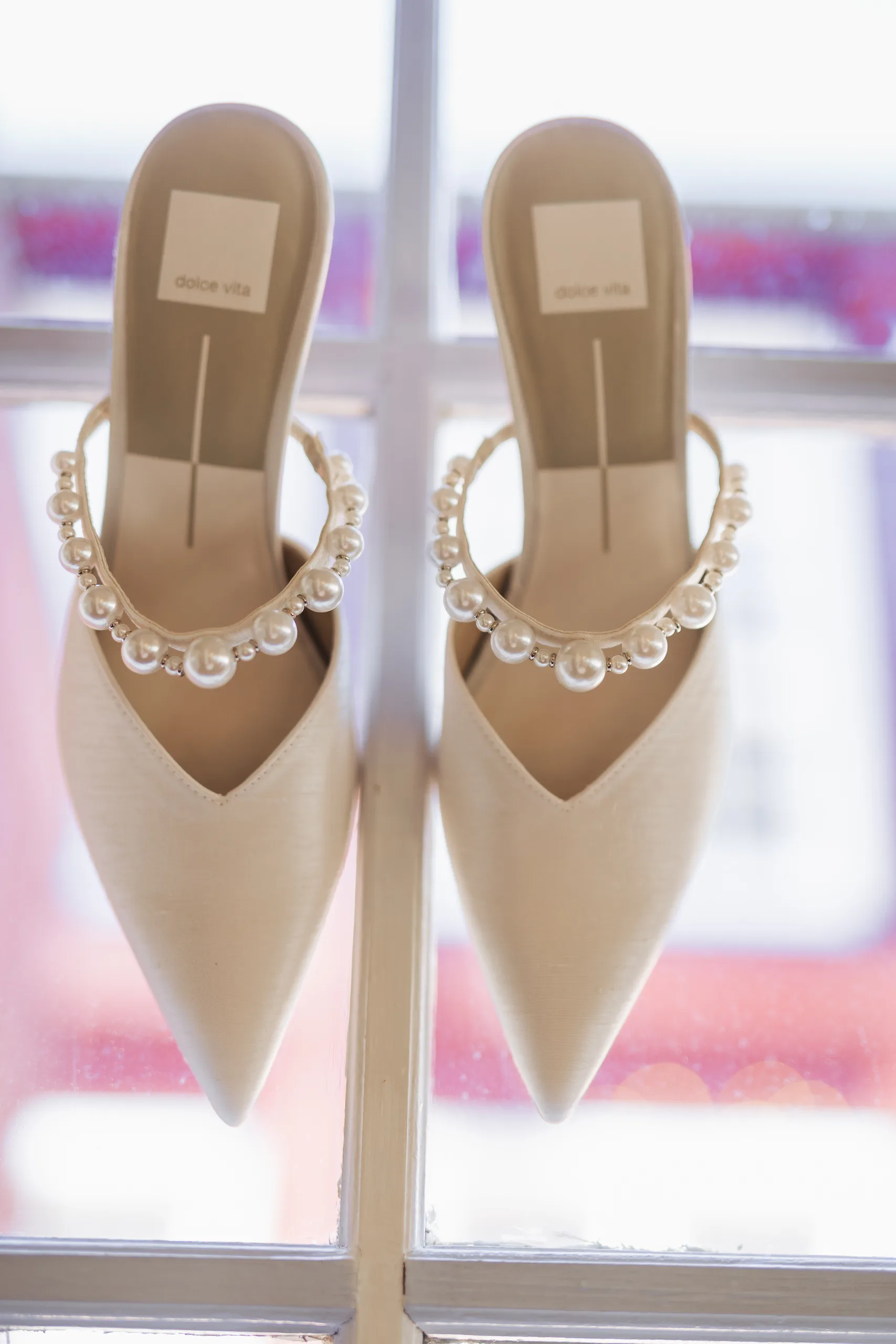 Wedding Details: her pearl-strapped heels on the windowsill at a wedding at Ivy Hall at Roswell Mill in Roswell, GA