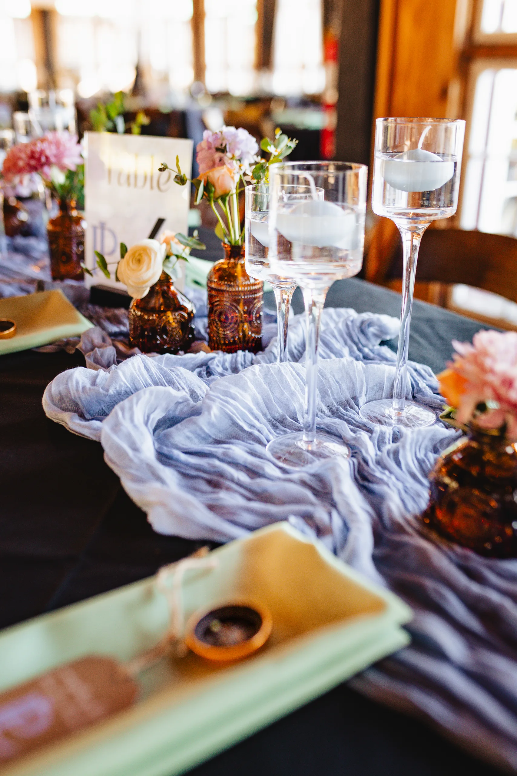 Reception Details: candles, bud vases and a blue runner on the table at a wedding at Ivy Hall at Roswell Mill in Roswell, GA