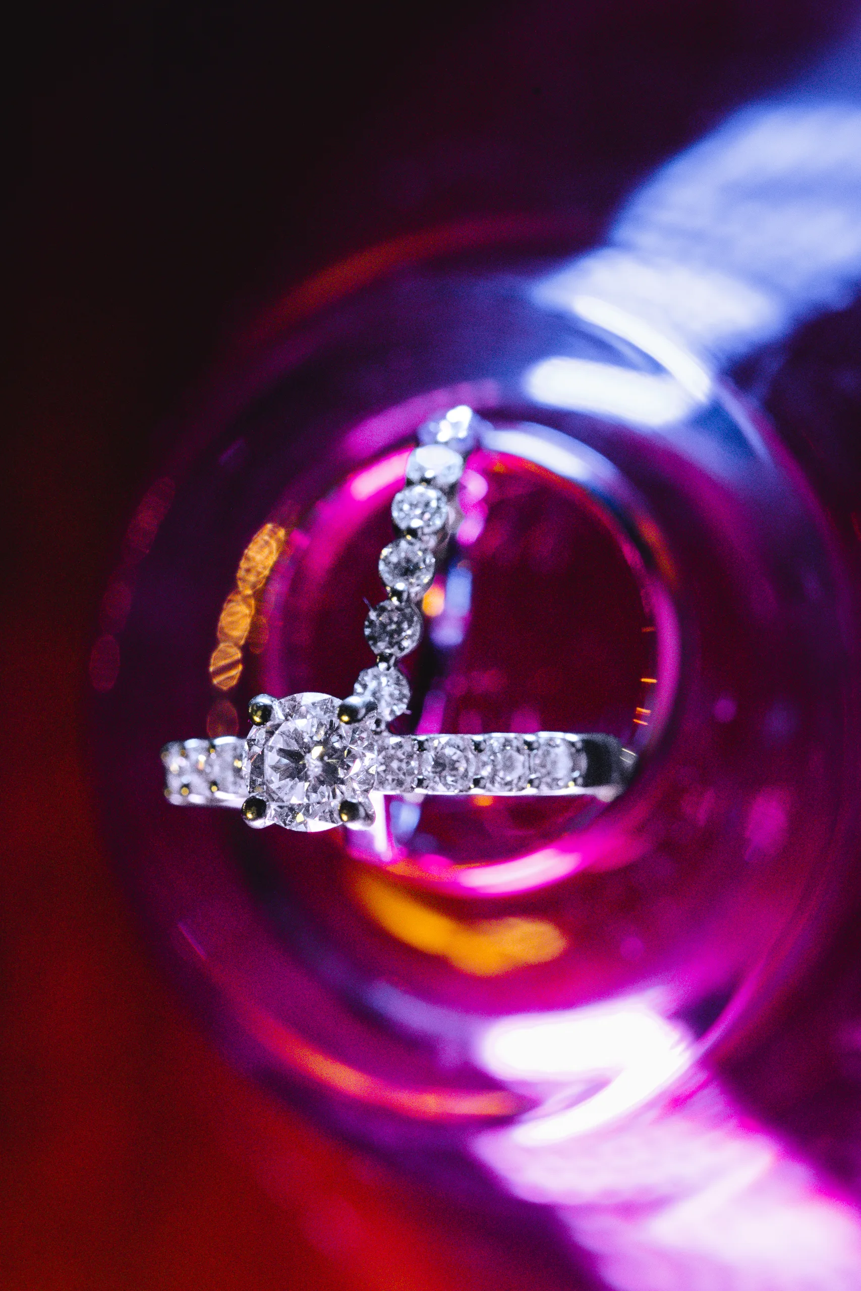 Wedding Details: her rings in pink light at a wedding at Ivy Hall at Roswell Mill in Roswell, GA
