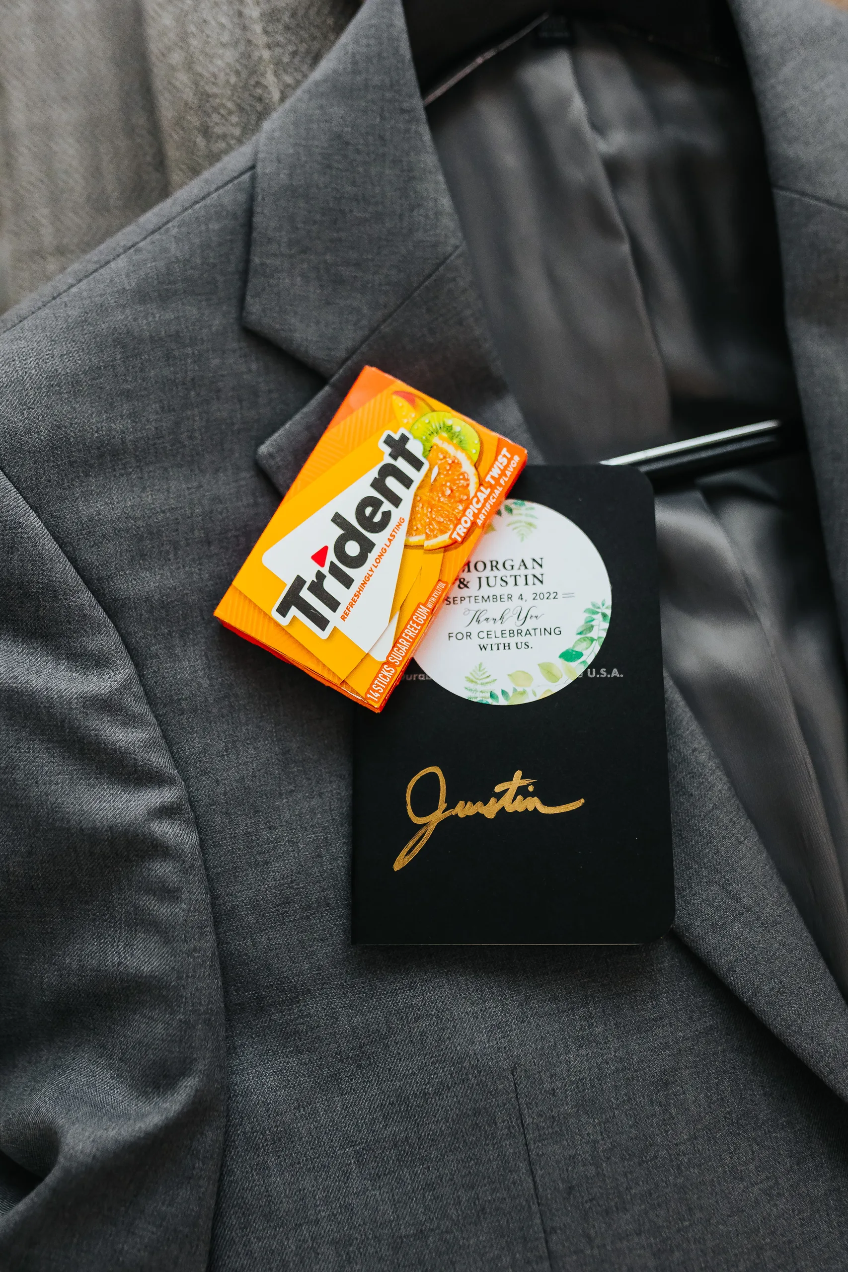 Wedding Details: his vow book and a pack of gum on his grey jacket, at a wedding at Terminus 330 in Atlanta, GA