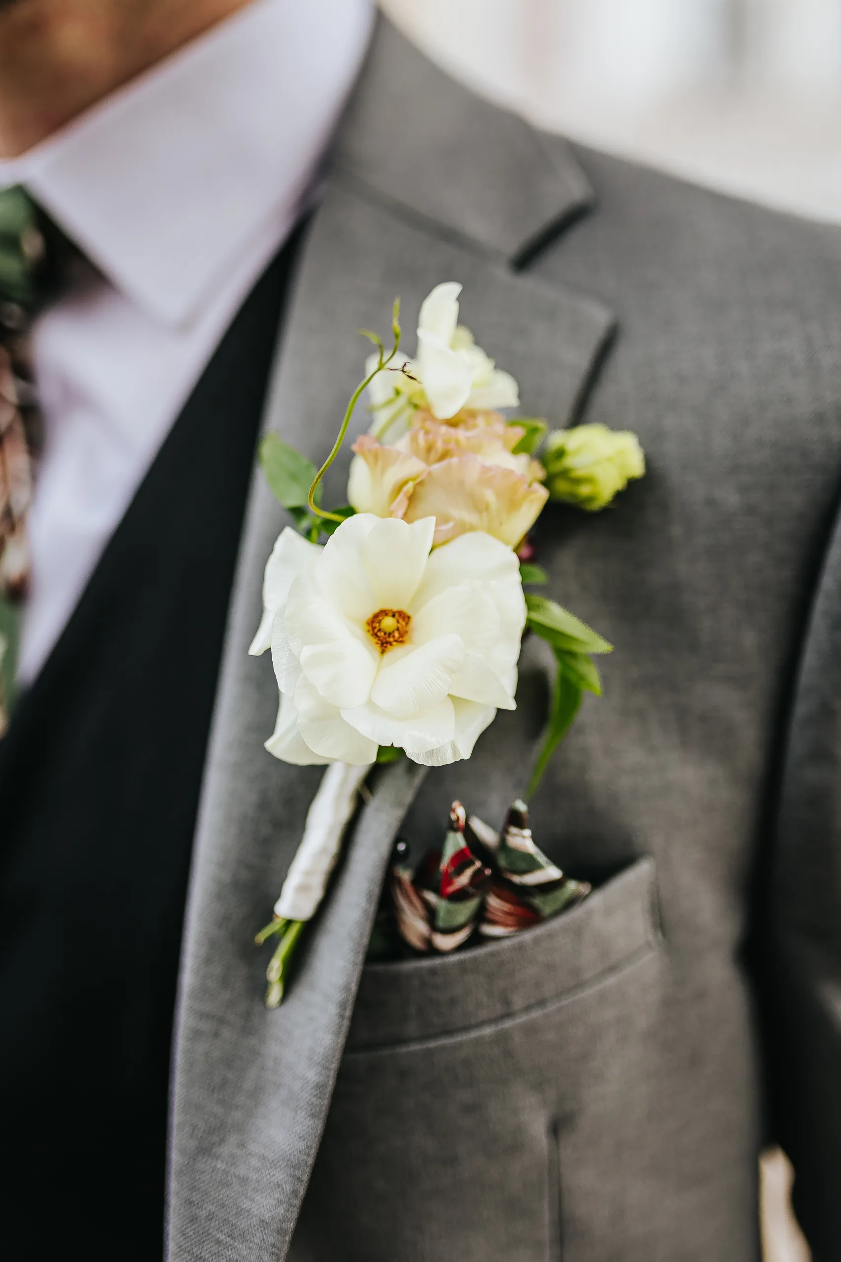 Wedding Details: his boutonniere and patterned pocket square, at a wedding at Terminus 330 in Atlanta, GA