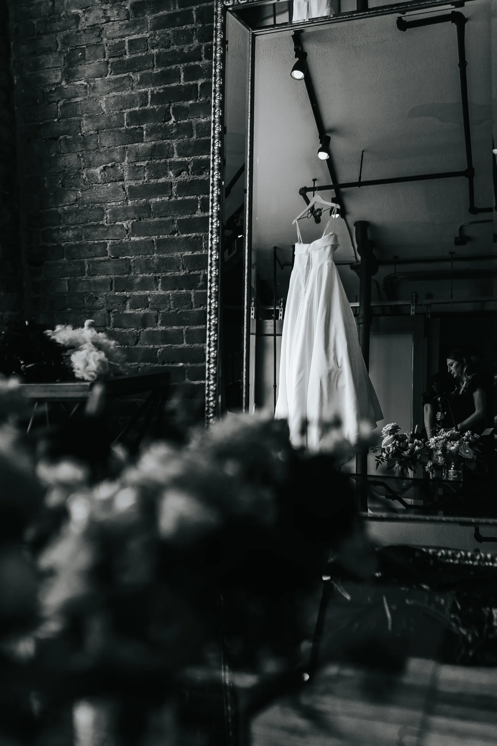 Wedding Details: her gown reflected in a tall mirror, in black and white, at a wedding at Terminus 330 in Atlanta, GA