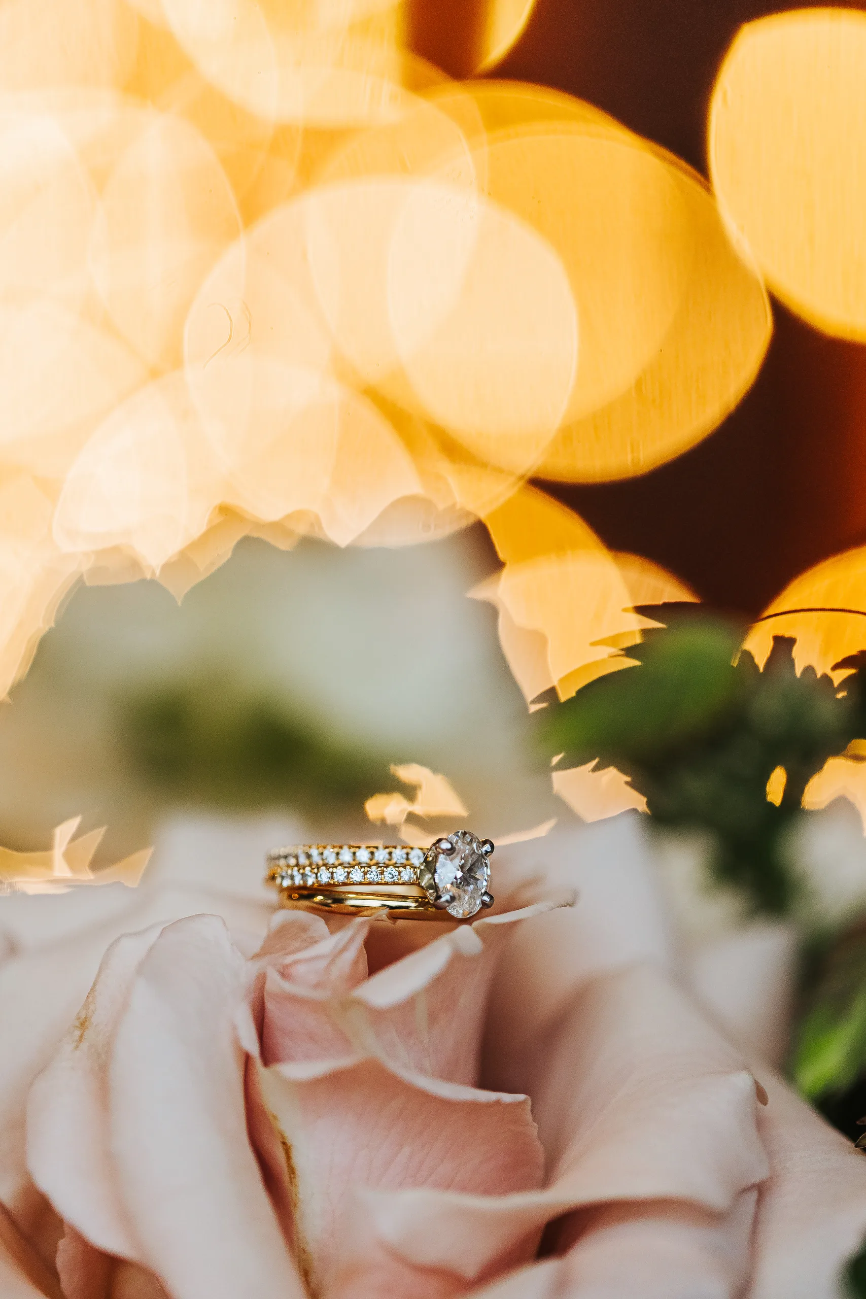Wedding Details: her engagement ring and band resting on a blush rose, at a wedding at Terminus 330 in Atlanta, GA