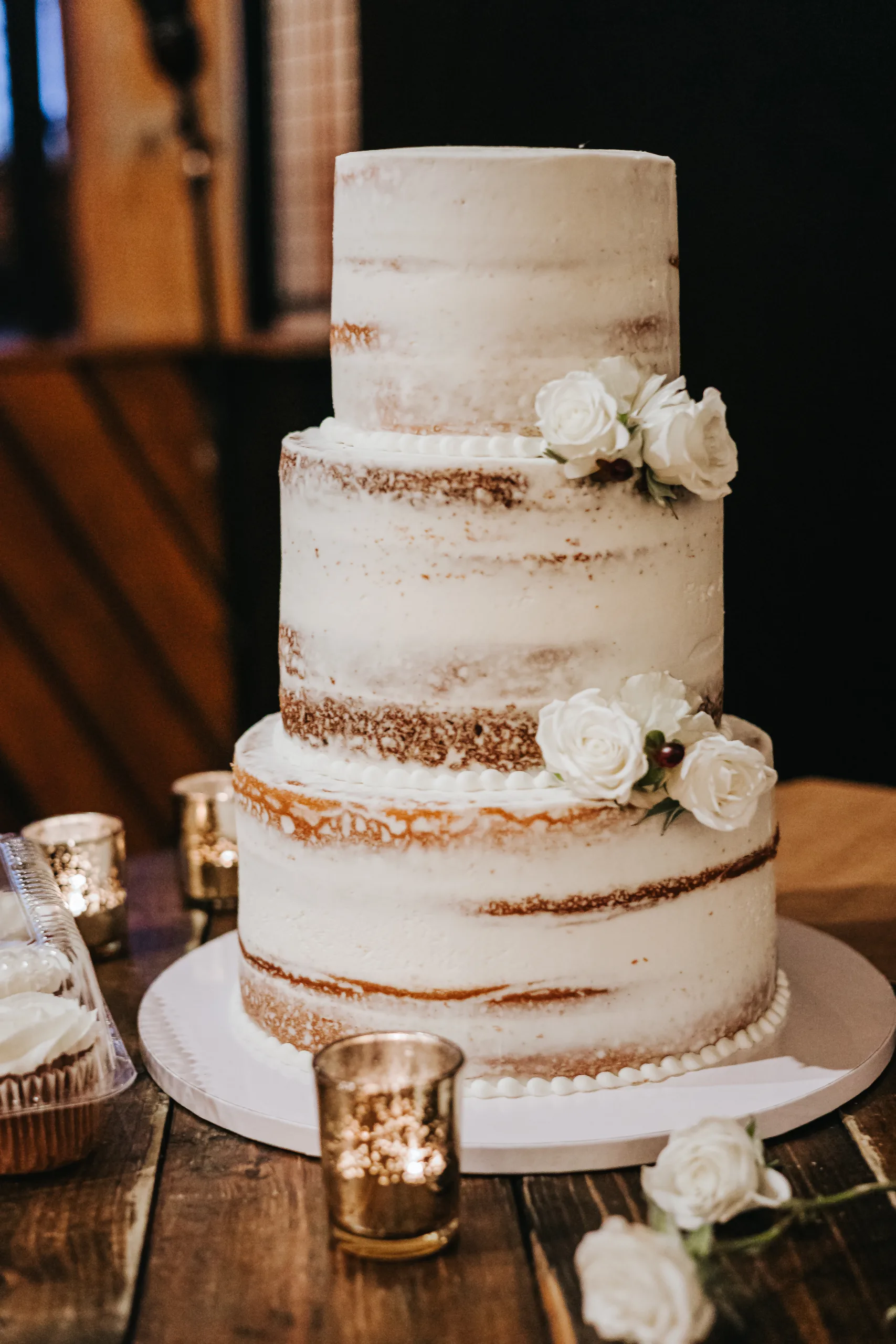 Wedding Cake Details: the three-tier naked cake with white roses, at a wedding at Terminus 330 in Atlanta, GA