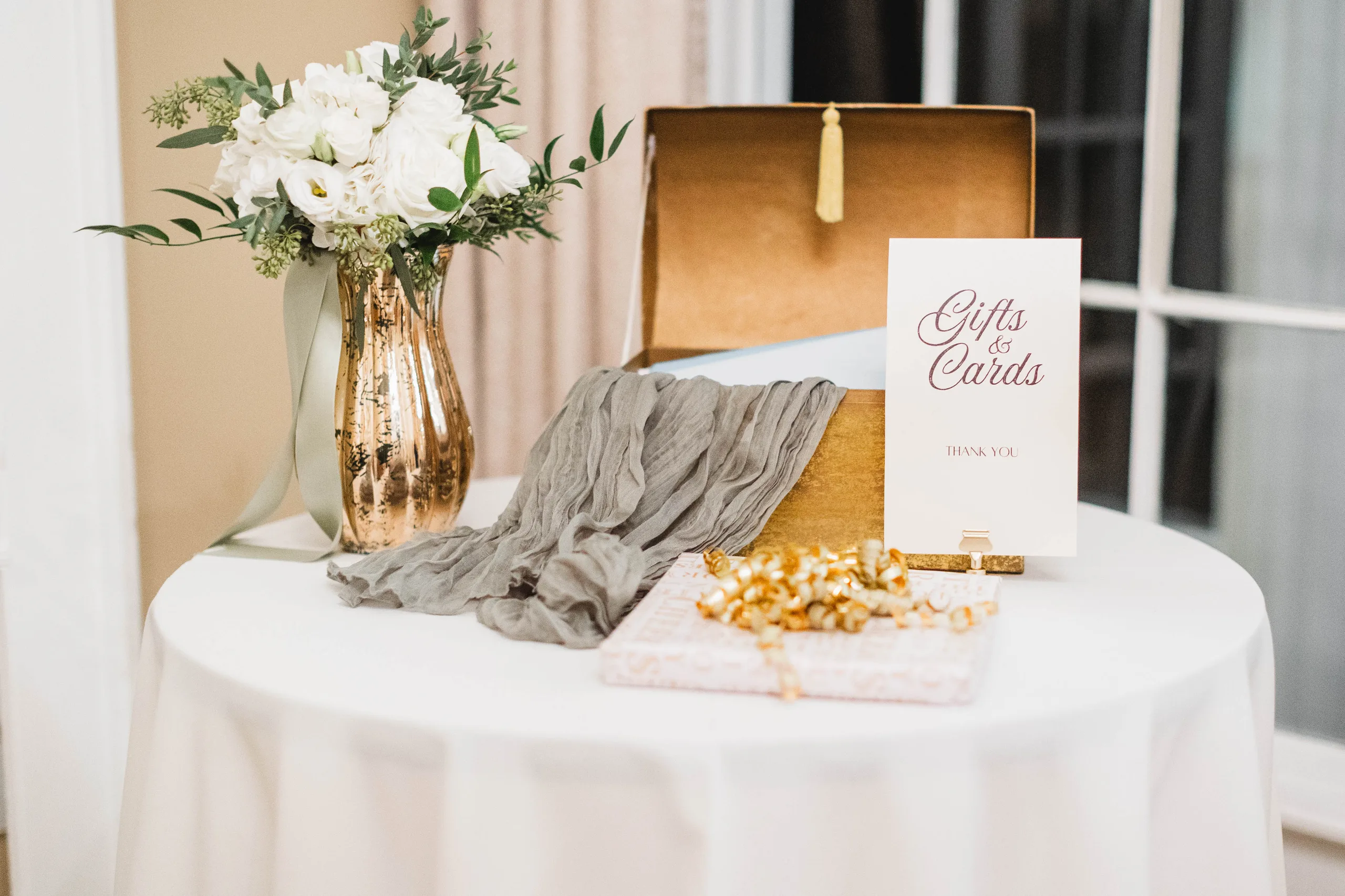 Reception Details: the gifts and cards table with a gold card box, at a wedding at Naylor Hall in Roswell, GA