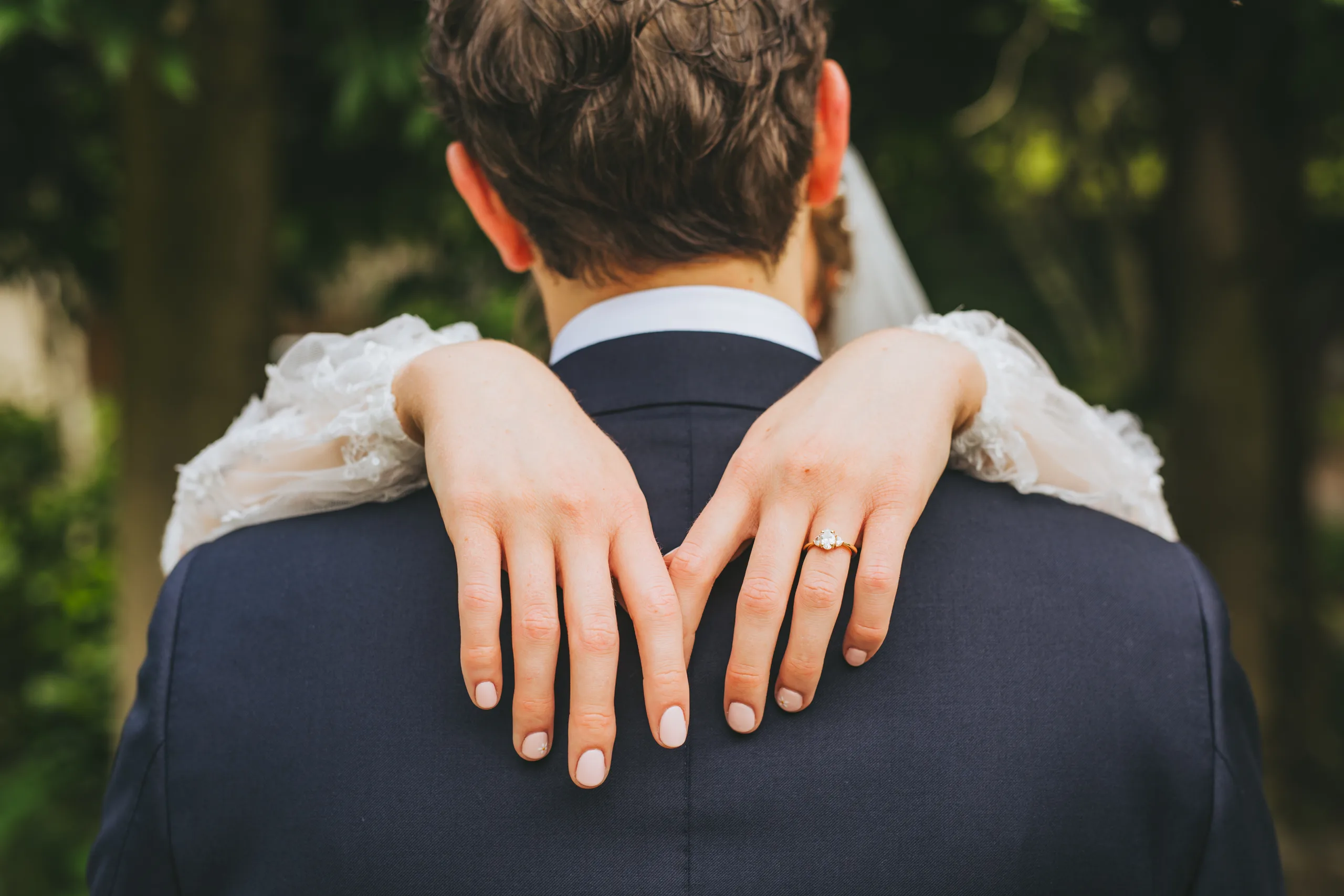 Wedding Details: her hands and ring on his shoulders, on their wedding day at Cator Woolford Gardens in Atlanta, GA