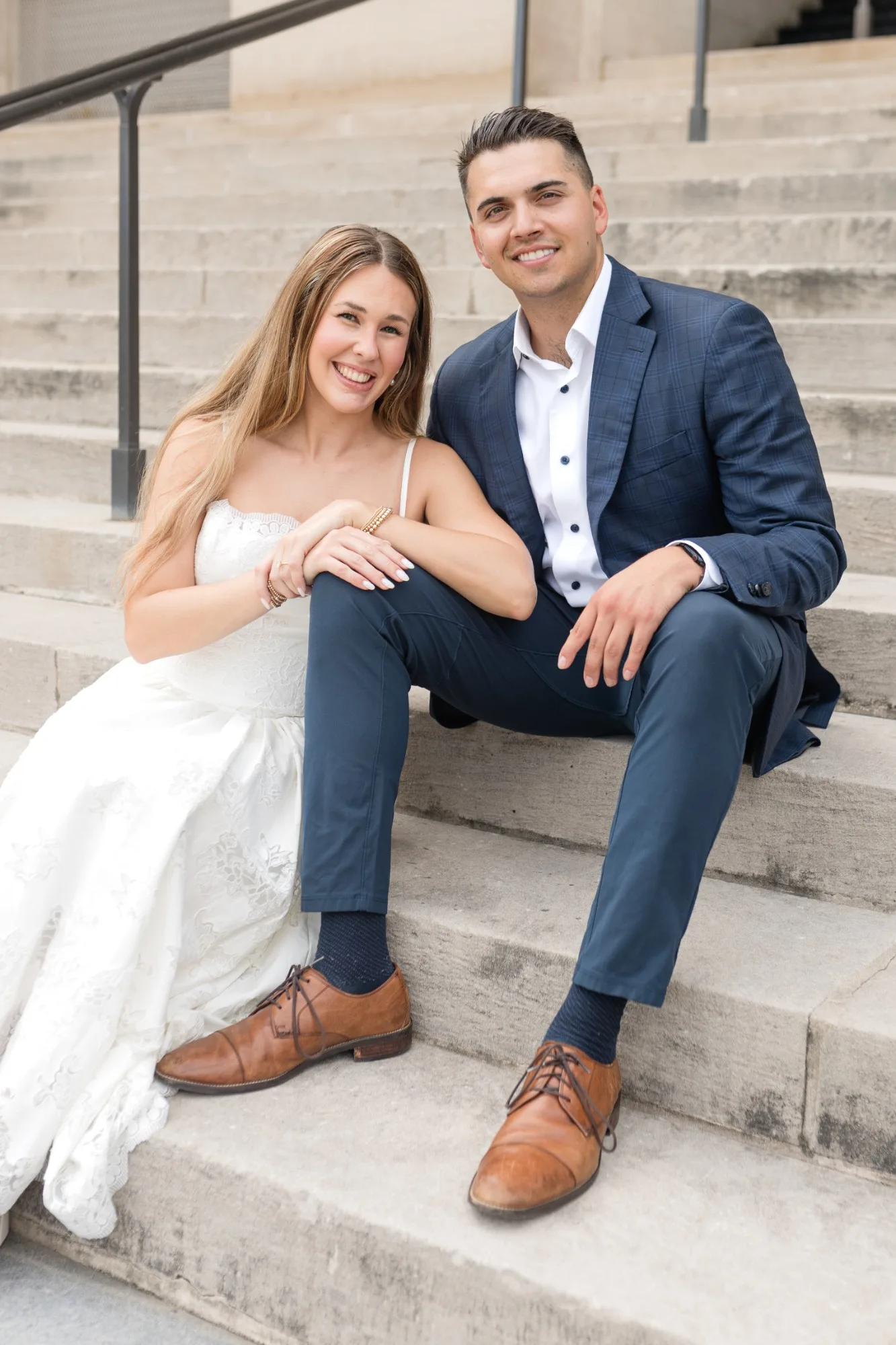 Capitol Grounds: sitting together on the stone steps, smiling at the camera, at their engagement session at the Georgia State Capitol in Atlanta, GA