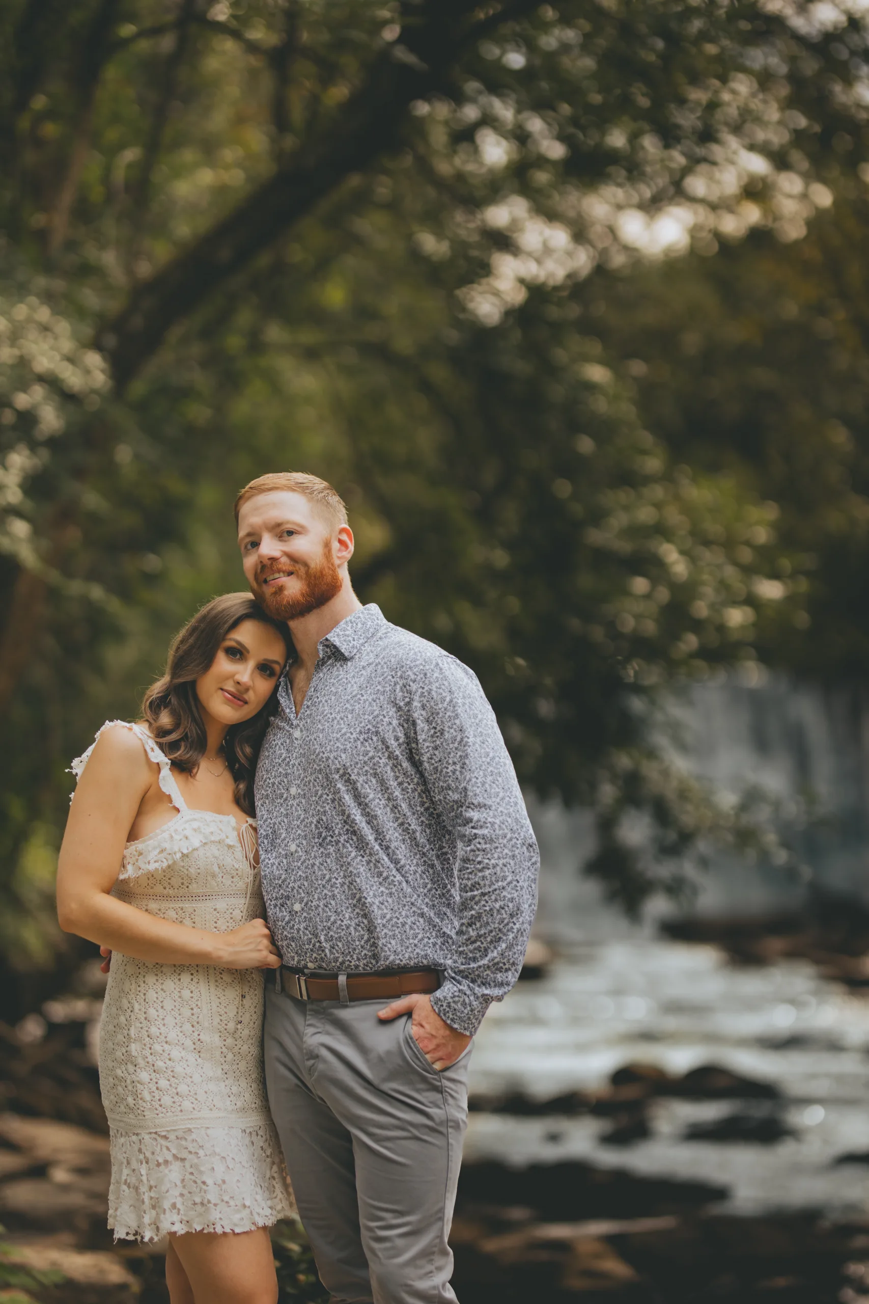 Engagement: close together by the creek, at their engagement session at Roswell Mill in Roswell, GA