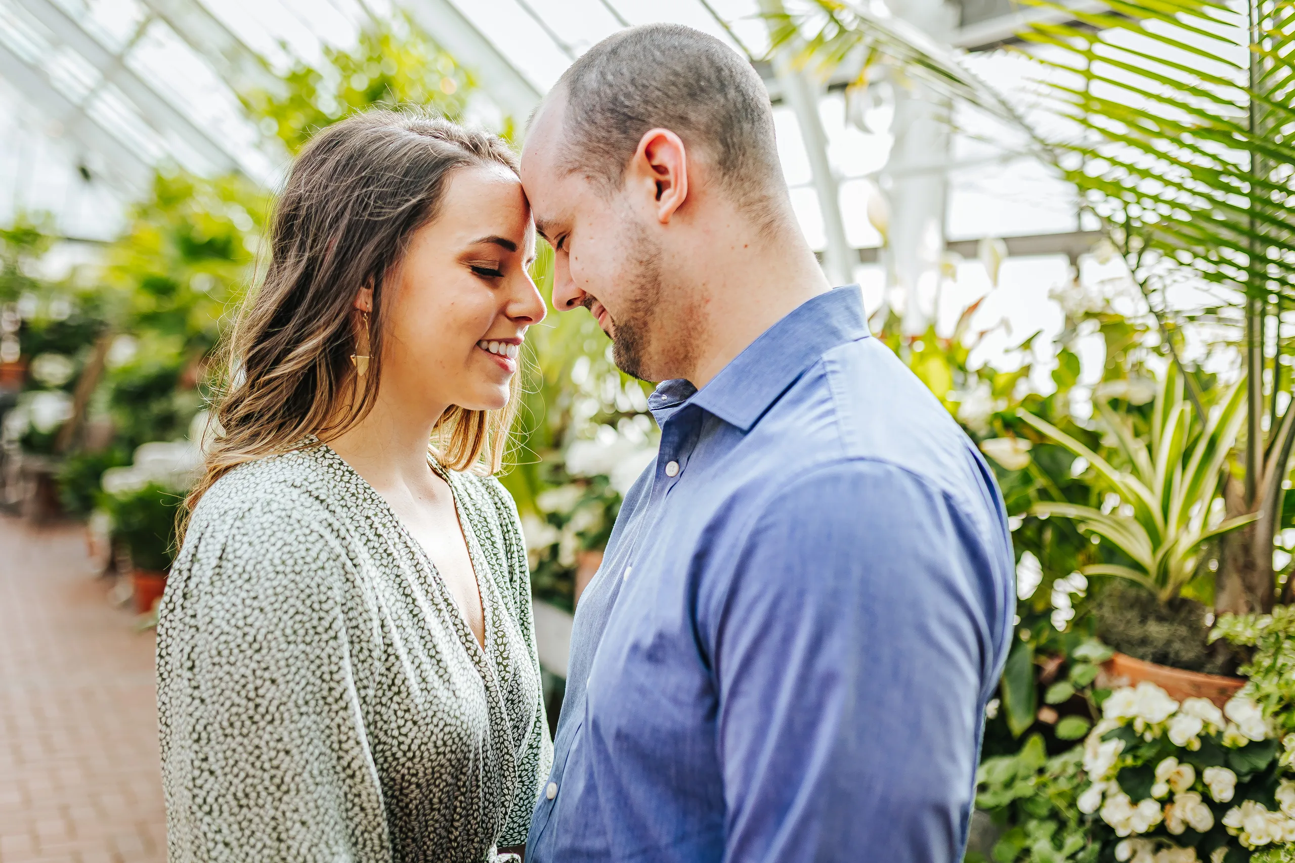 Conservatory: foreheads together under the glass roof, at their engagement session at Biltmore Estate in Asheville, NC