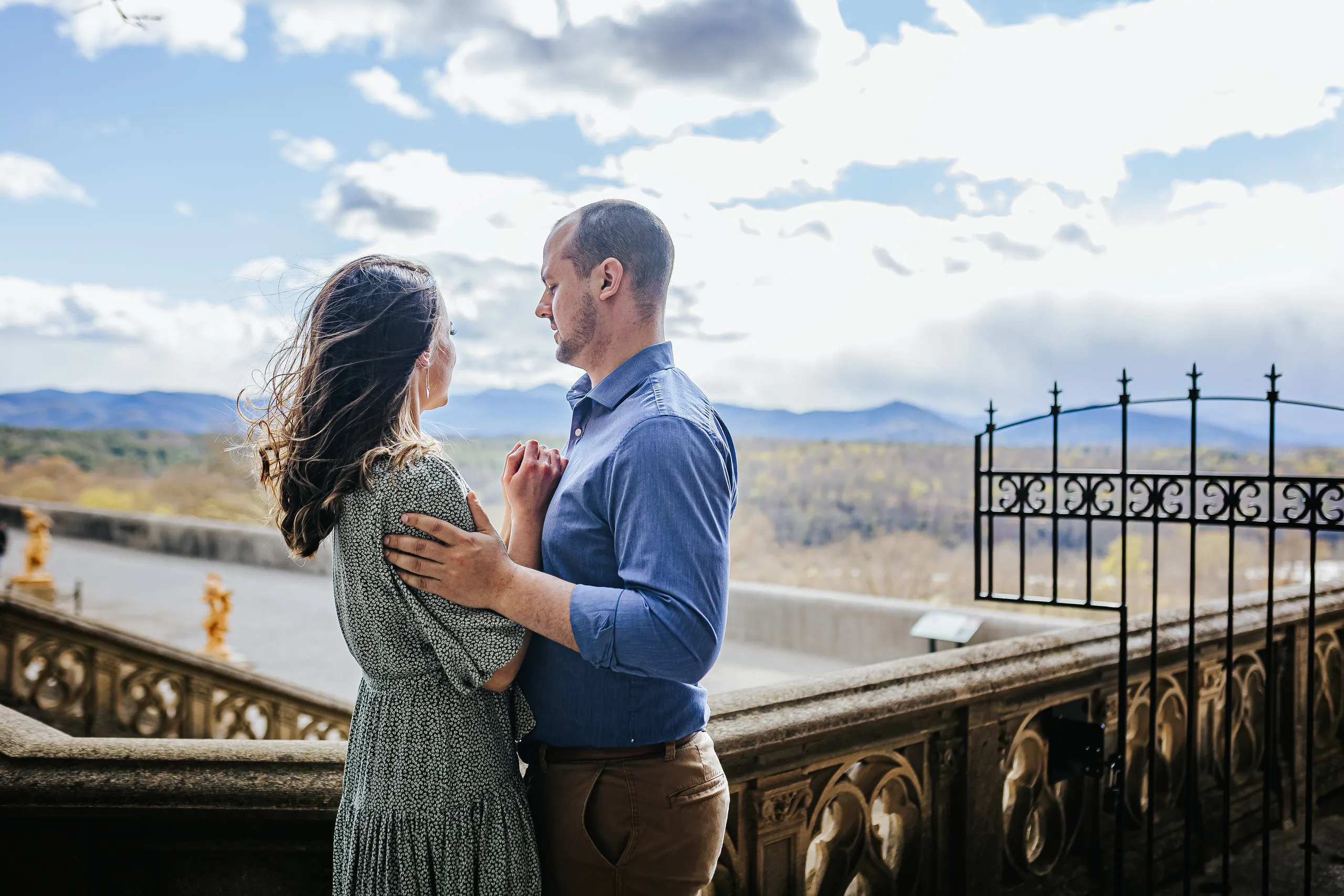 Terrace: looking out over the Blue Ridge Mountains, at their engagement session at Biltmore Estate in Asheville, NC