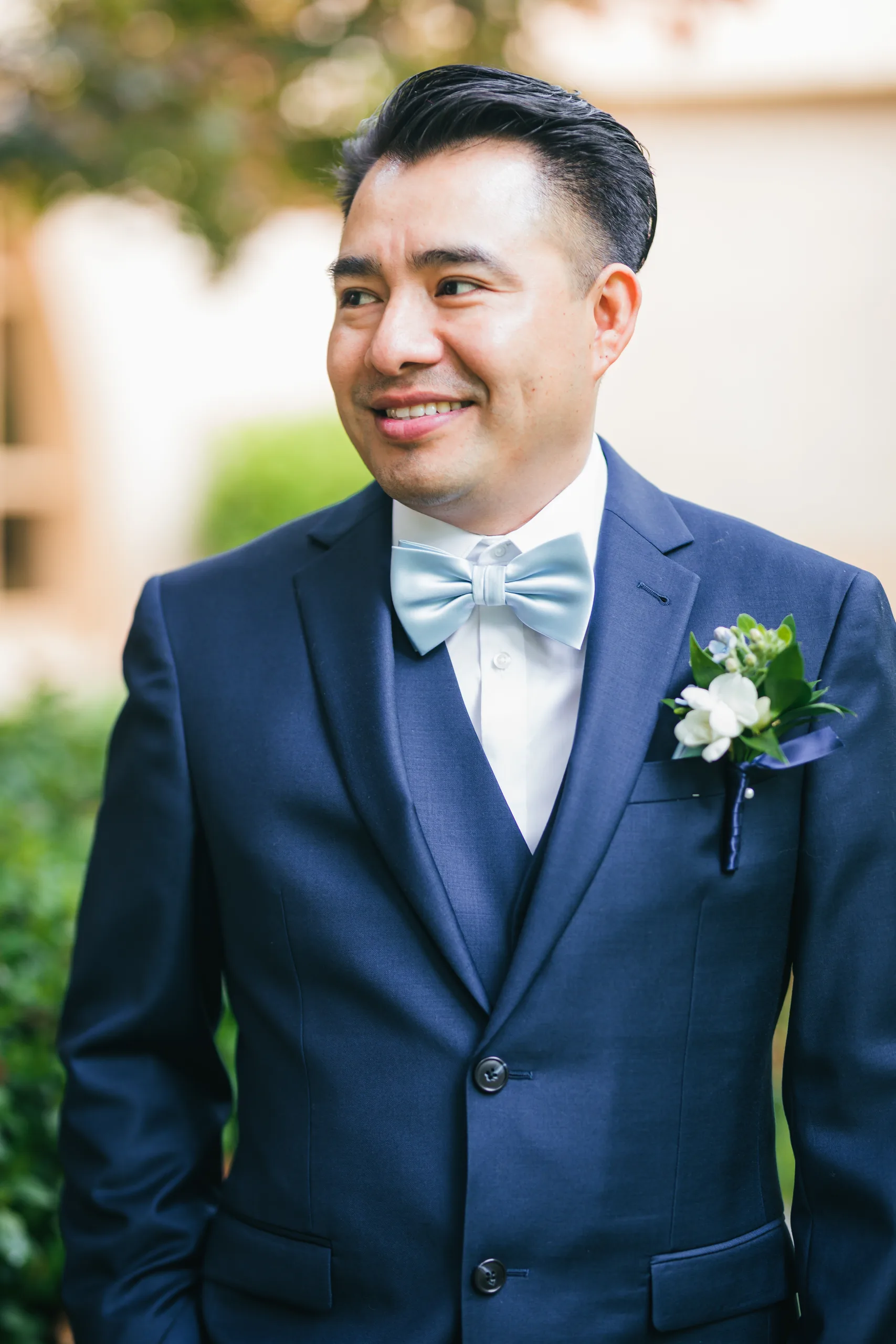 Wedding Formals: the groom smiling in his navy suit before their wedding at Holy Cross Catholic Church in Atlanta, GA