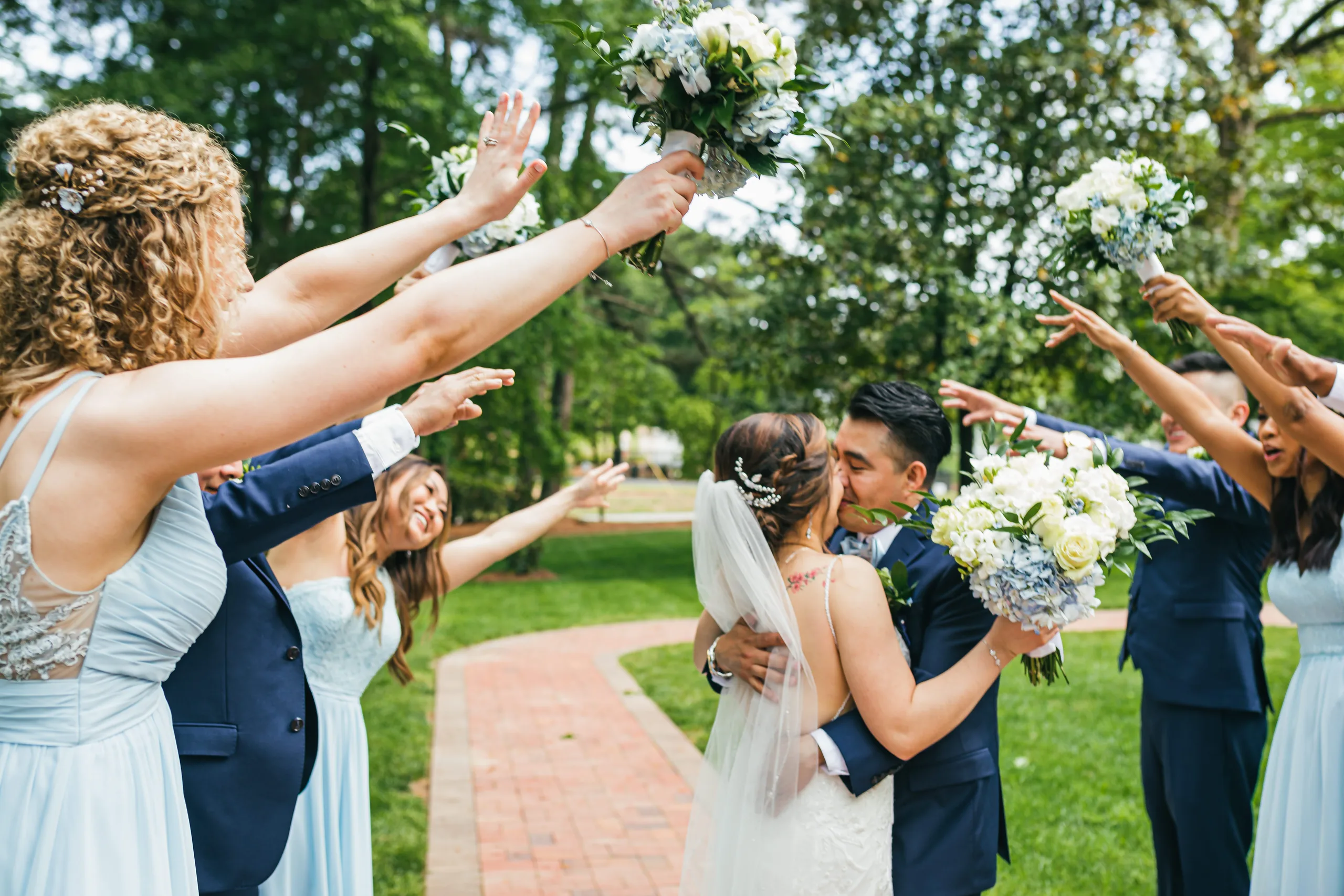 Wedding Party: the bridesmaids cheering as the couple kisses at their wedding at the Payne-Corley House in Duluth, GA