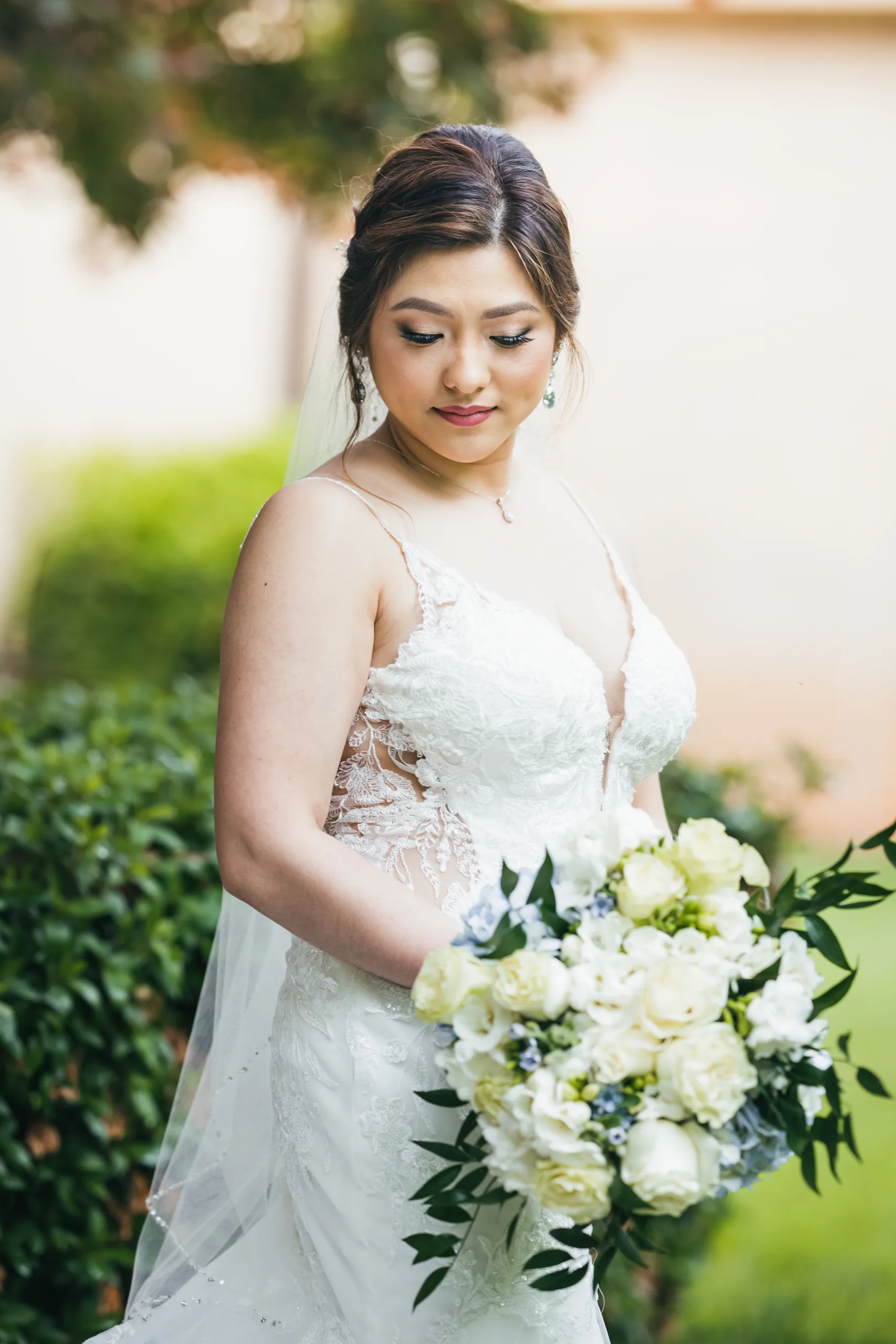 Bridal Portraits: the bride with her white bouquet before their wedding at Holy Cross Catholic Church in Atlanta, GA
