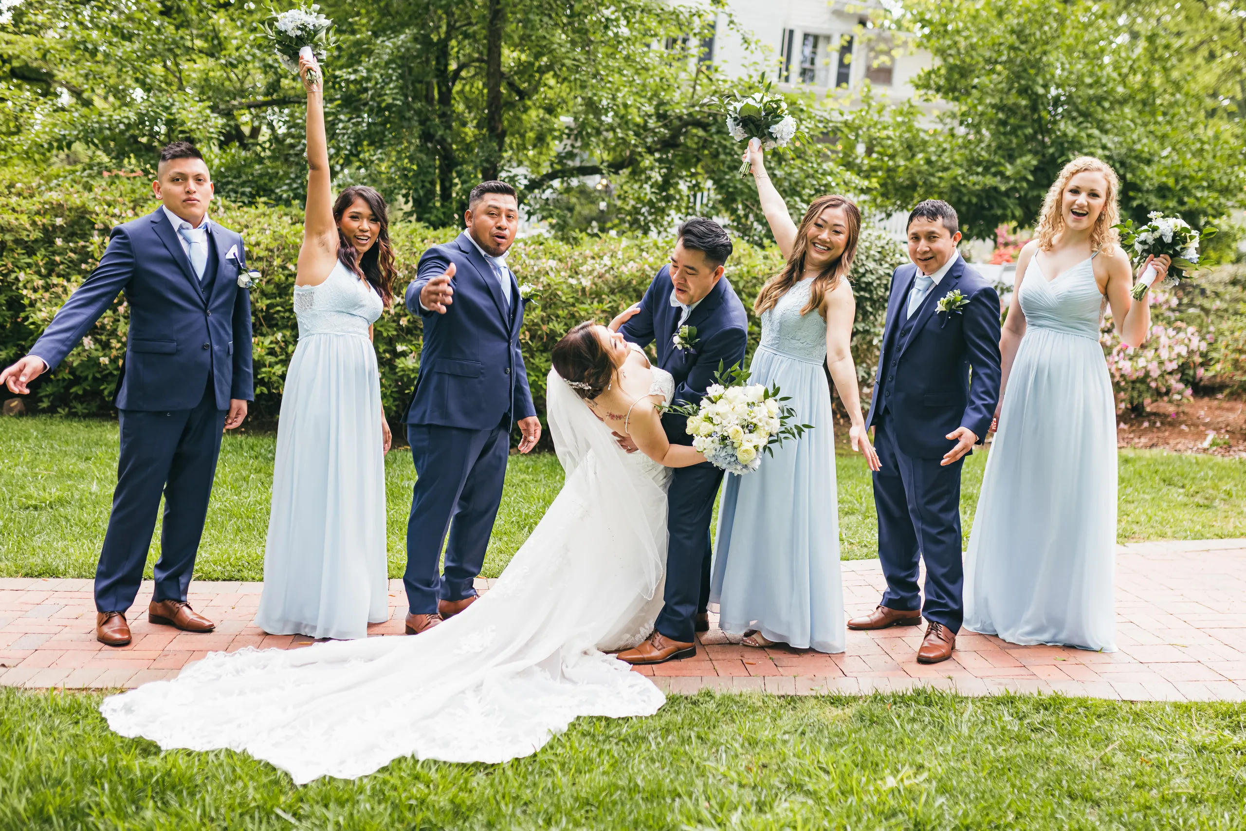 Wedding Party: a dip on the lawn with the wedding party cheering at their wedding at the Payne-Corley House in Duluth, GA