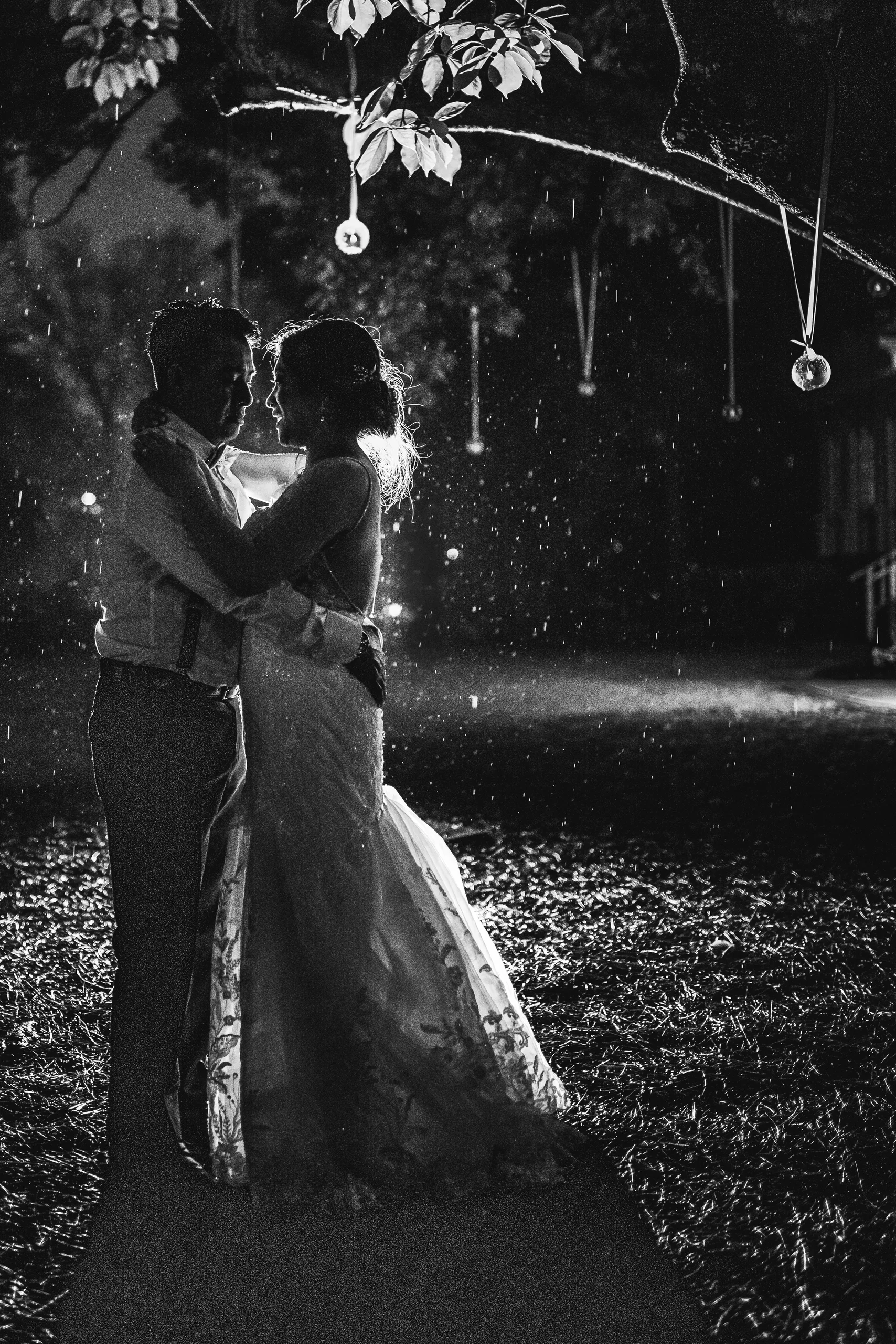 Night Portraits: embracing under the trees at night, in black and white at their wedding at the Payne-Corley House in Duluth, GA