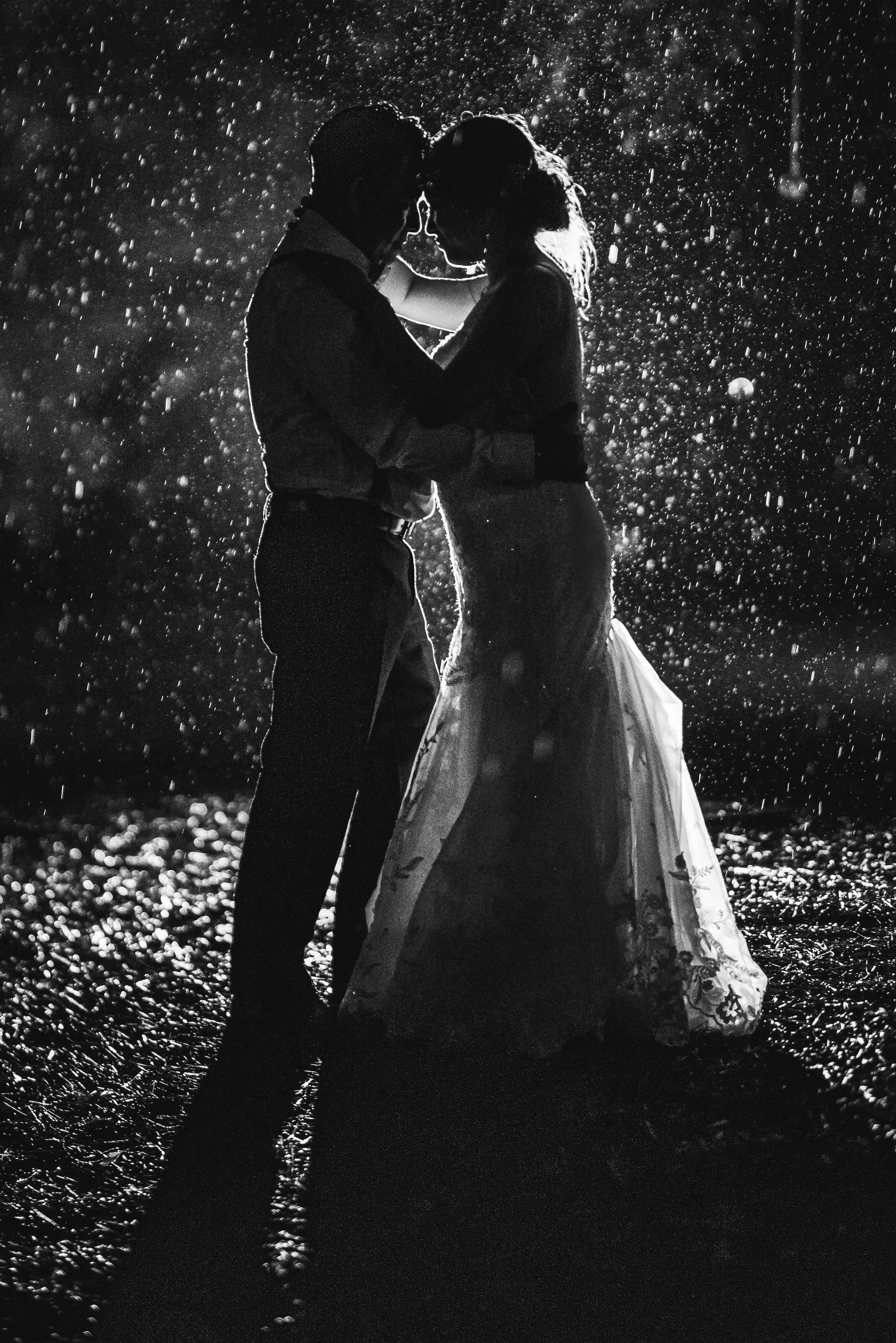 Night Portraits: a kiss in the rain, in black and white at their wedding at the Payne-Corley House in Duluth, GA
