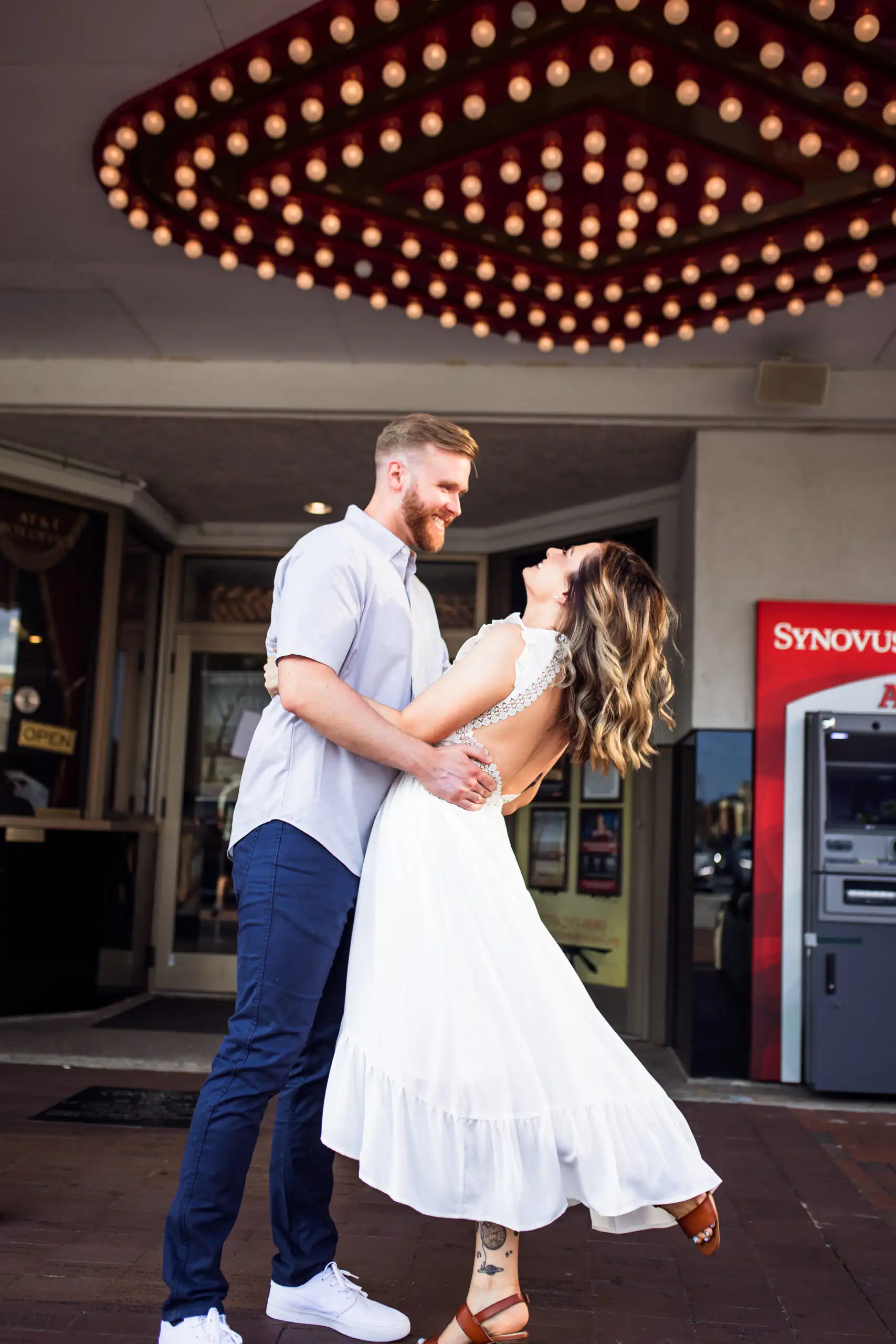 Wedding Formals: a dip beneath the theater marquee lights, after their courthouse wedding on Marietta Square in Marietta, GA
