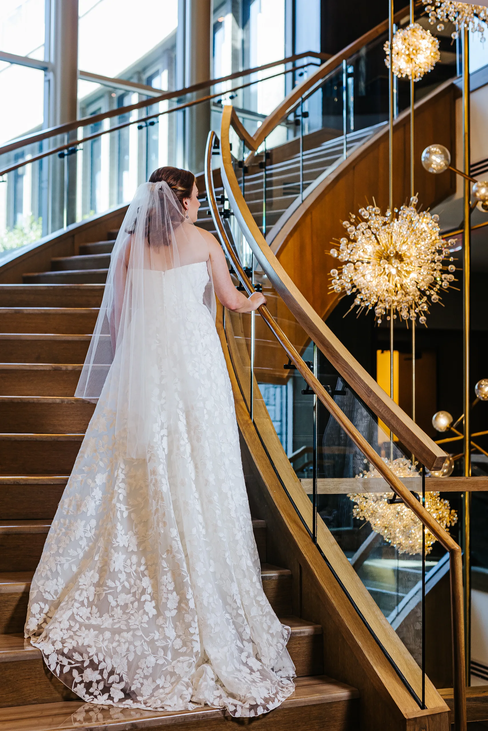 Bridal Portraits: the bride on the curved wood staircase at their wedding at the Omni Hotel at The Battery in Atlanta, GA