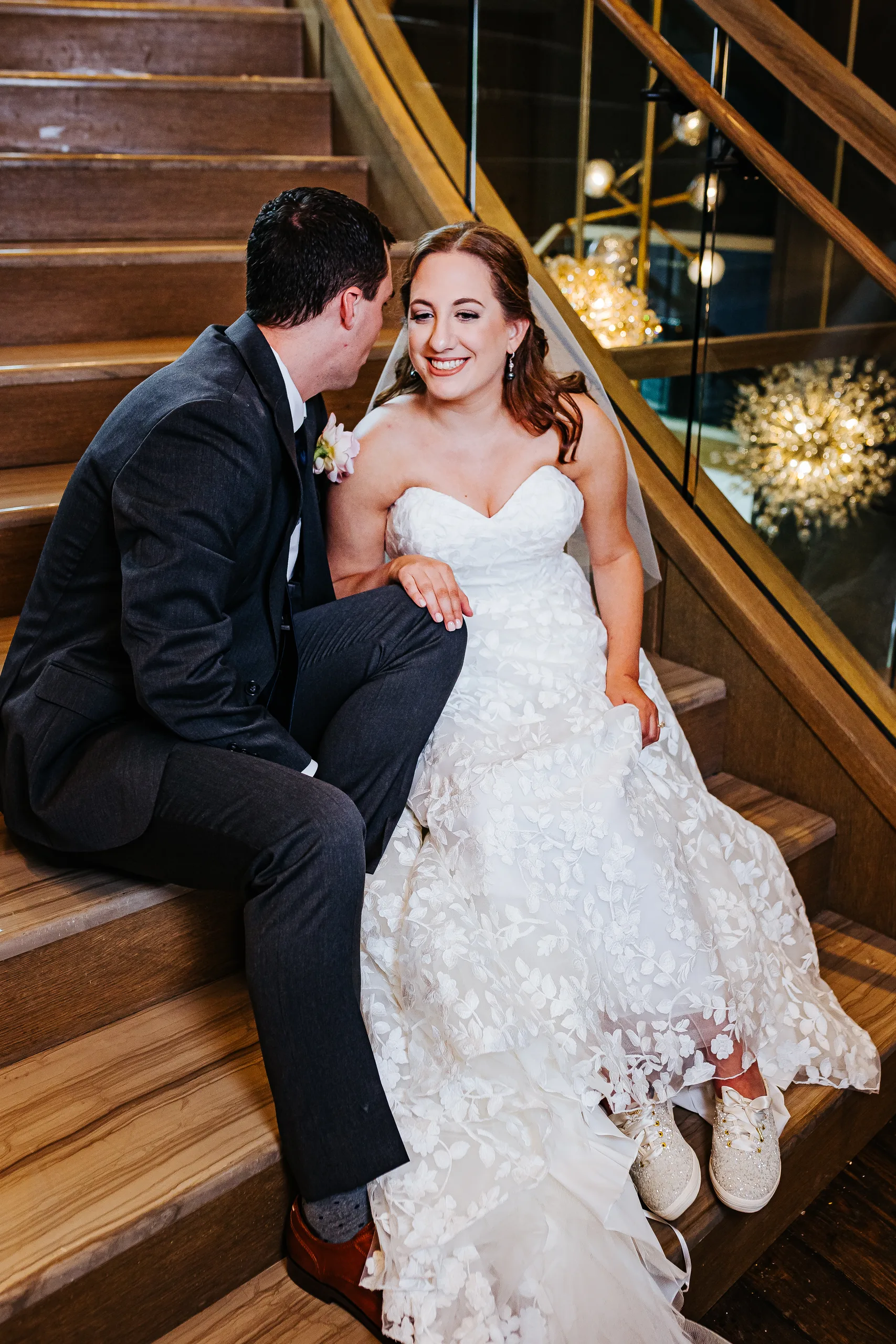 Wedding Formals: laughing together on the staircase at their wedding at the Omni Hotel at The Battery in Atlanta, GA