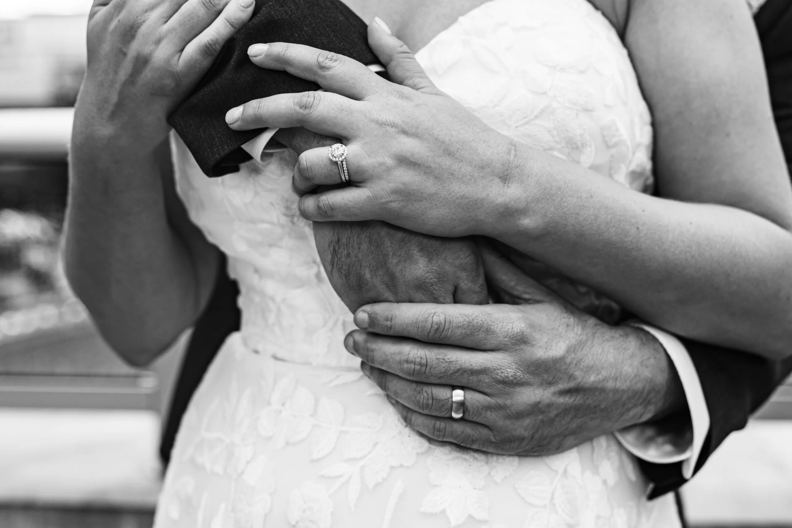 Wedding Formals: his arms around her showing both rings, in black and white at their wedding at the Omni Hotel at The Battery in Atlanta, GA