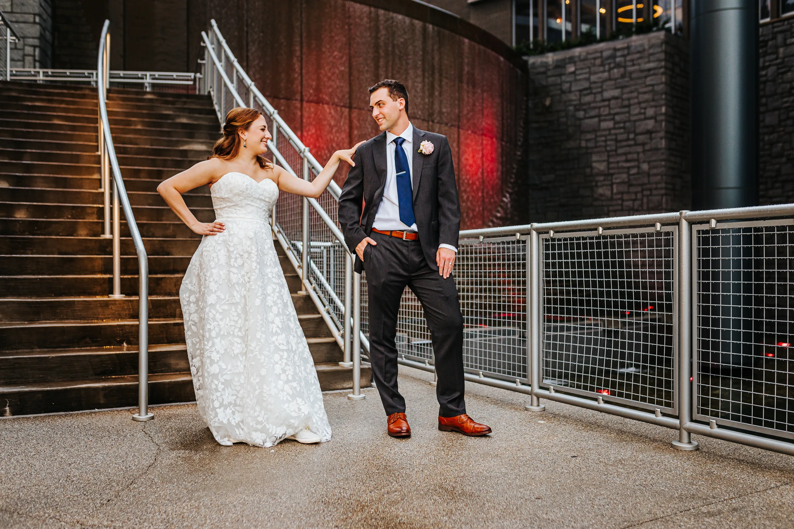Wedding Formals: striking a pose by the stairs at night at their wedding at the Omni Hotel at The Battery in Atlanta, GA
