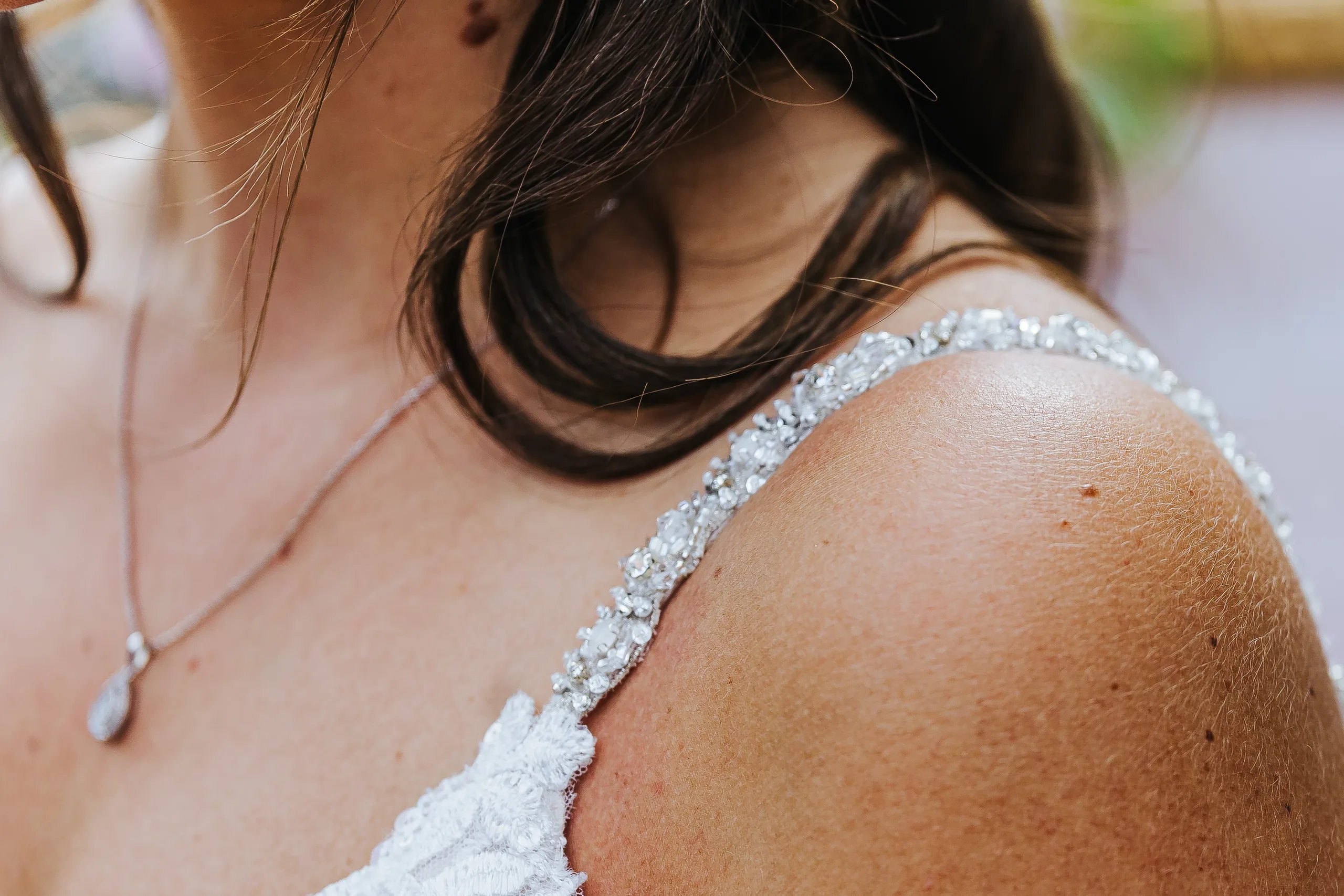 Bridal Portraits: the beaded strap of her gown and her necklace, at their wedding at The Piedmont Room in Atlanta, GA