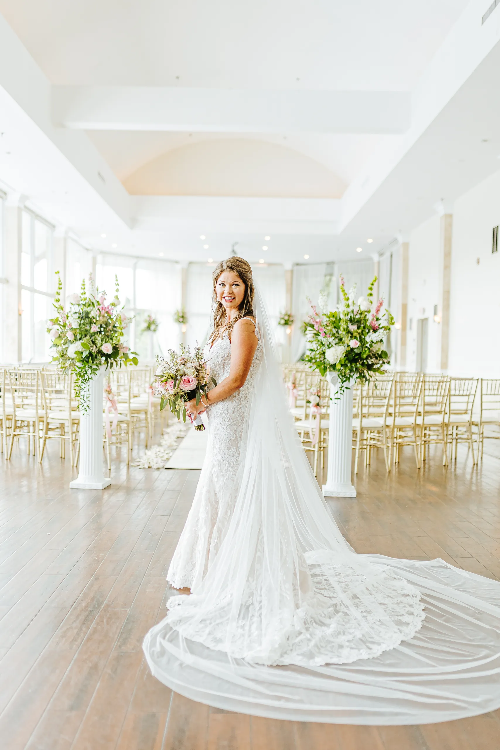 Bridal Portraits: the bride in the ceremony room with her long veil, at their wedding at The Piedmont Room in Atlanta, GA