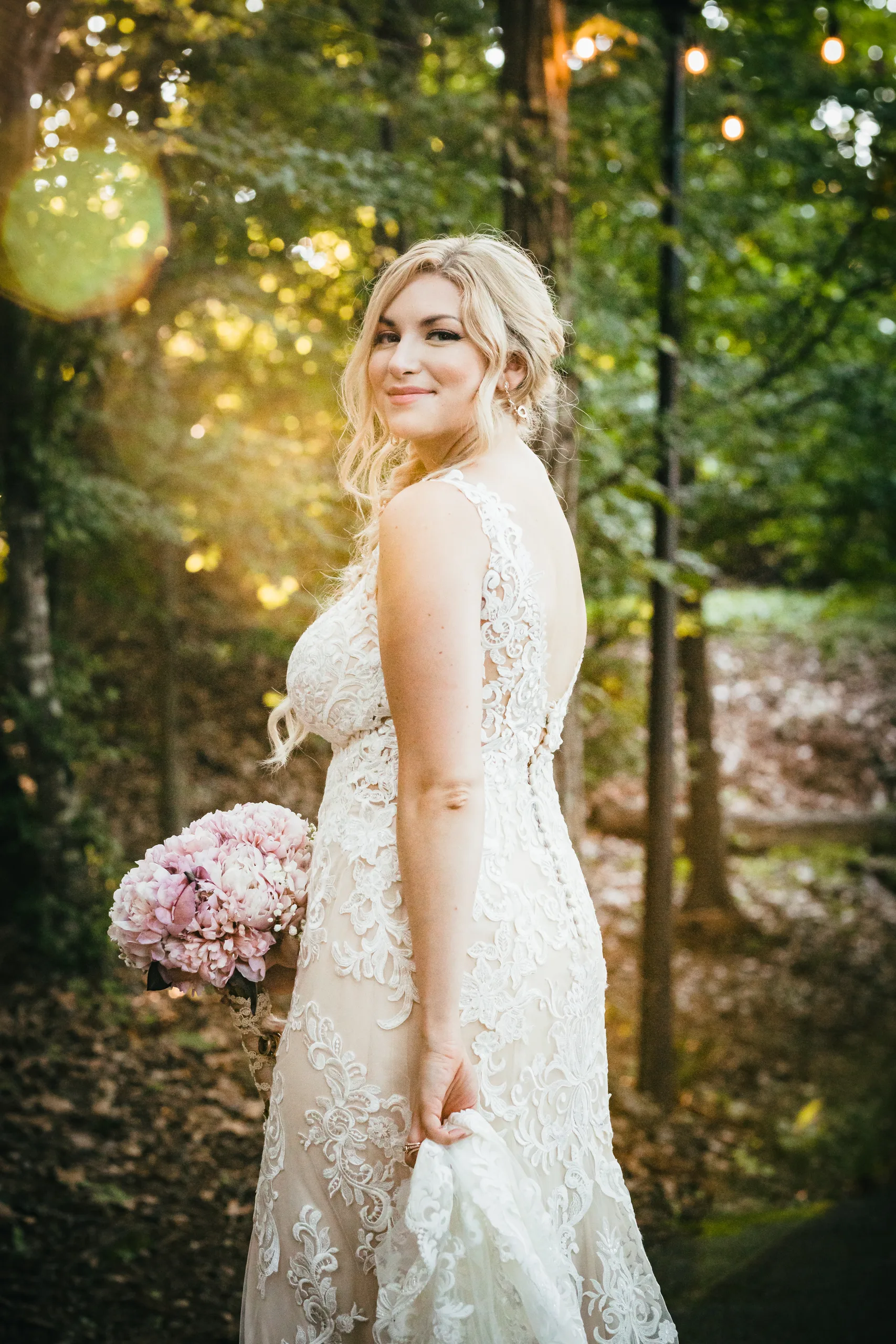 Bridal Portraits: the bride looking back over her shoulder in the woods, at their wedding at Atlanta Evergreen Lakeside Resort in Stone Mountain, GA
