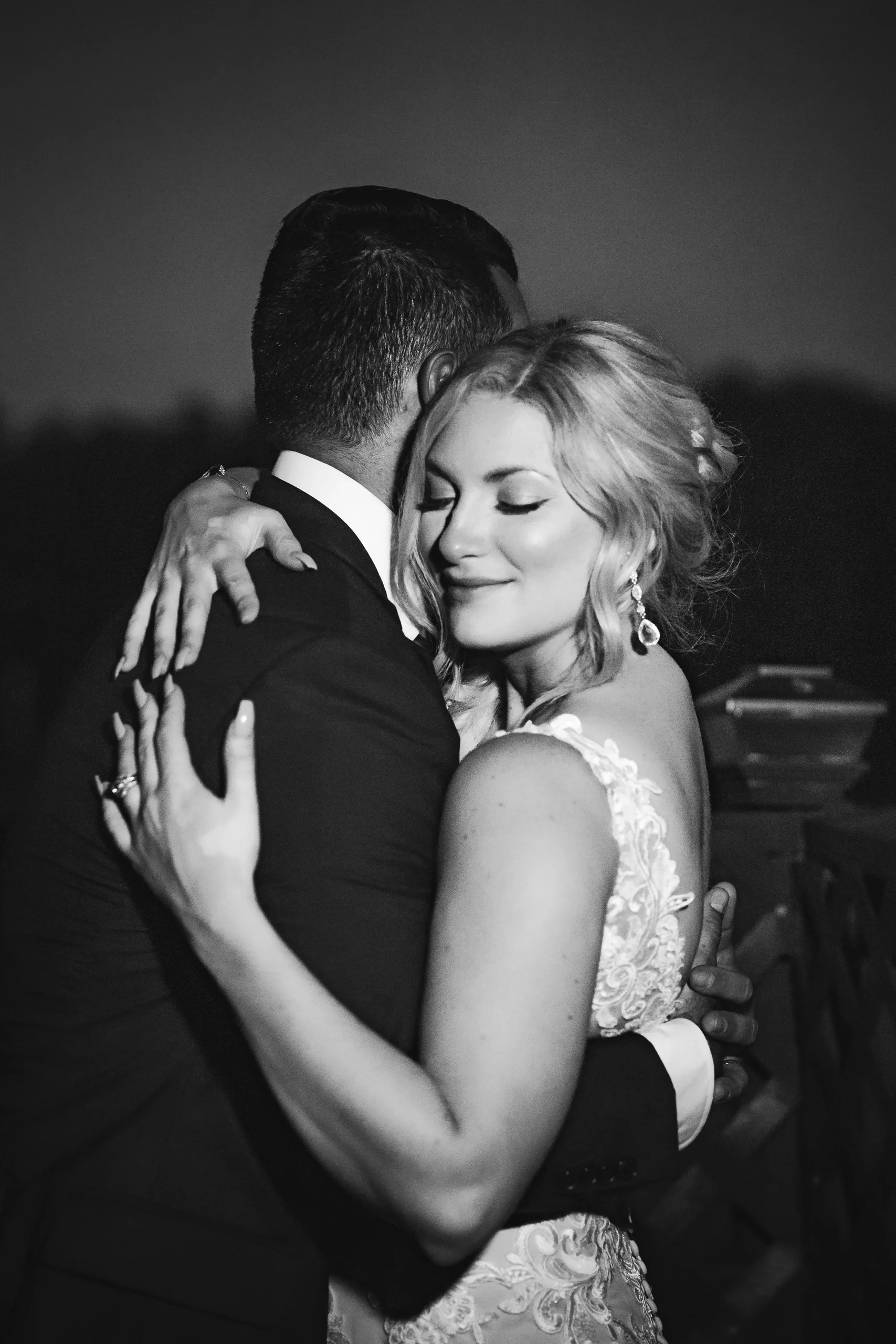 Wedding Formals: an embrace at night, in black and white, at their wedding at Atlanta Evergreen Lakeside Resort in Stone Mountain, GA